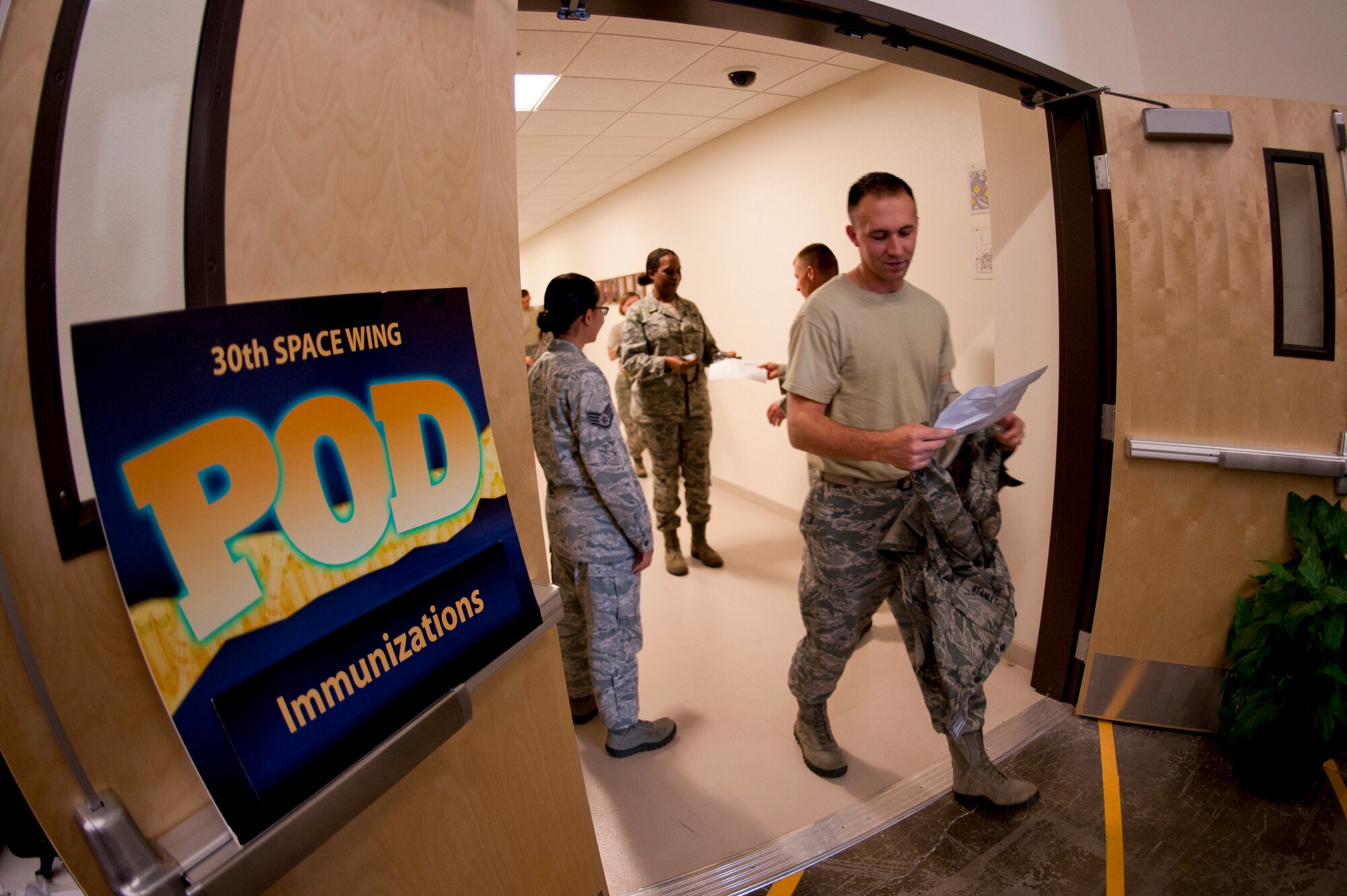 VANDENBERG AIR FORCE BASE, Calif. – After a quick medical records screening, Team V members proceed to the inoculation area at the Point of Distribution (POD) in the Installation Deployment Readiness Cell here Thursday, Oct. 18, 2012. Active duty Airmen reported to the POD in an exercise simulating mass immunization against anthrax, and base authorities used the opportunity to distribute this year’s real world influenza vaccine.  The POD distributed Skittles candy representing the anthrax prophylaxis to over 1,900 Airmen and then vaccinated over 1,500 Airmen for influenza, raising the wing’s flu vaccination rate to over 90%.  The purpose of the exercise was toevaluate the wing’s response to a public health emergency by testing the 30th Medical Group’s ability to stand up a POD and rapidly distribute countermeasures. Mass inoculation of this scale was a first for Vandenberg Air Force Base. (U.S. Air Force photo/Senior Airman Lael Huss)