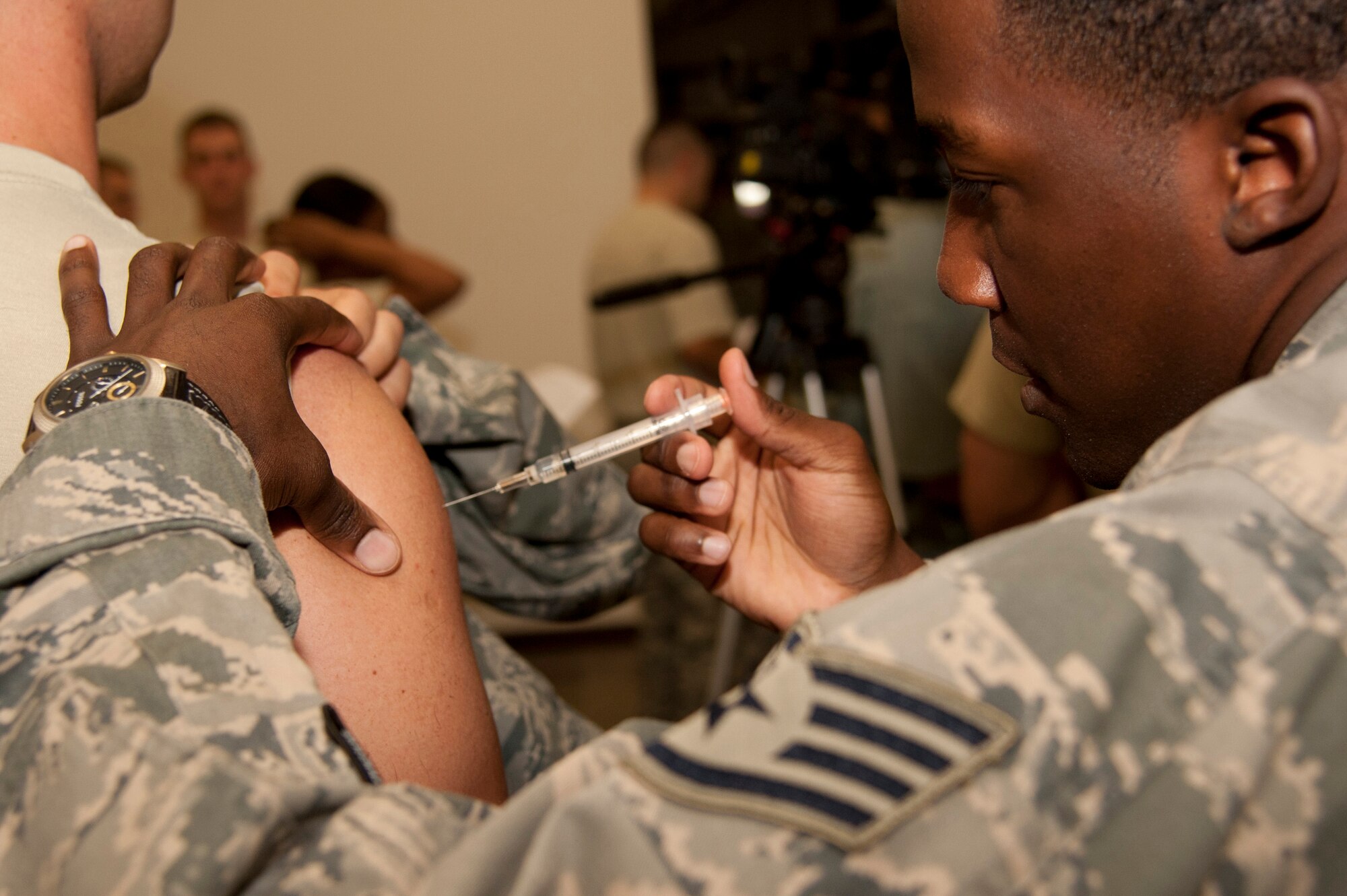 VANDENBERG AIR FORCE BASE, Calif. – Staff Sgt. Zavier Grier, 30th Medical Operations Squadron aerospace medical technician, administers the flu vaccine at the Point of Distribution (POD) in the Installation Deployment Readiness Cell here Thursday, Oct. 18, 2012.  Active duty Airmen reported to the POD in an exercise simulating mass immunization against anthrax, and base authorities used the opportunity to distribute this year’s real world influenza vaccine.  The POD distributed Skittles candy representing the anthrax prophylaxis to over 1,900 Airmen and then vaccinated over 1,500 Airmen for influenza, raising the wing’s flu vaccination rate to over 90%.  The purpose of the exercise was toevaluate the wing’s response to a public health emergency by testing the 30th Medical Group’s ability to stand up a POD and rapidly distribute countermeasures. Mass inoculation of this scale was a first for Vandenberg Air Force Base. (U.S. Air Force photo/Senior Airman Lael Huss)