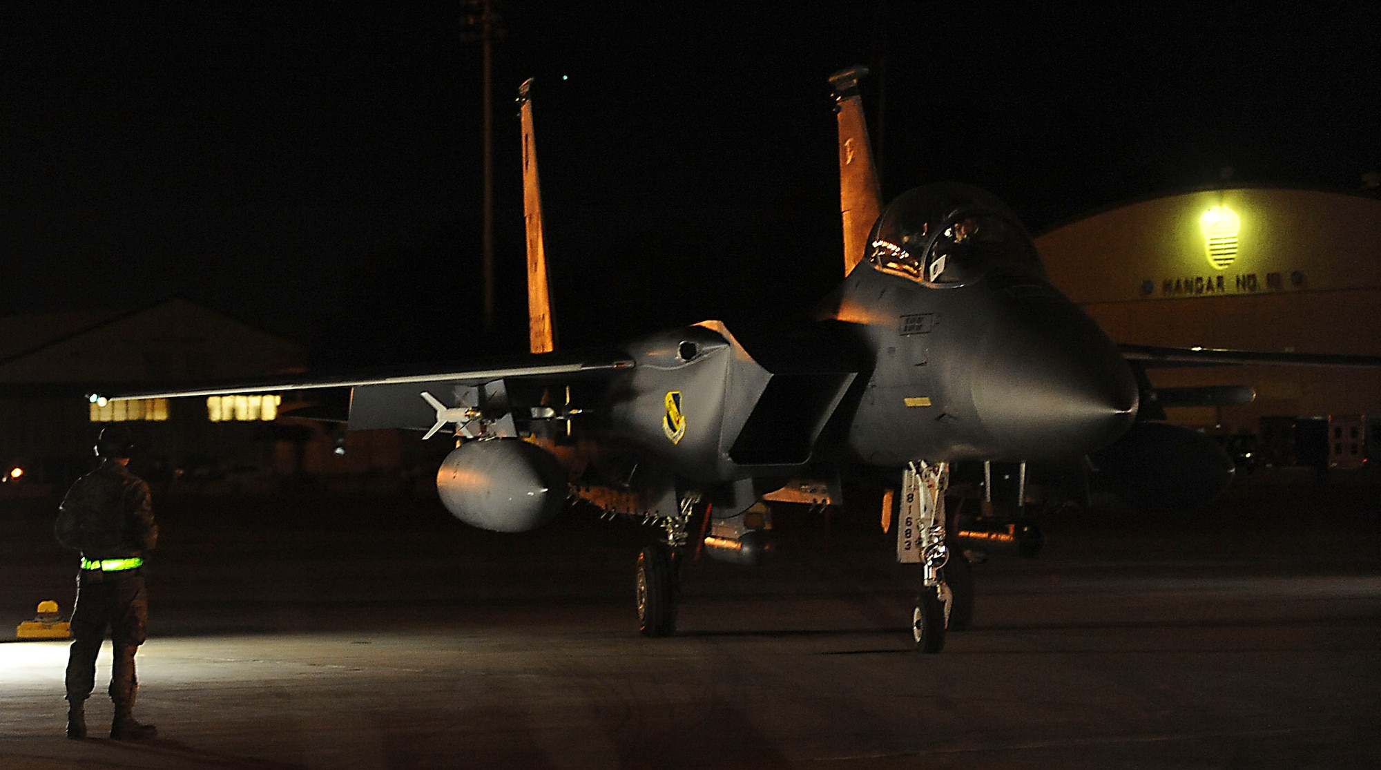 Senior Airman Joseph Newby, 335th Fighter Squadron, Seymour Johnson Air Force Base, N.C., crew chief, waits to taxi Capt. Caleb Guthman, F-15E Strike Eagle pilot, and Capt. Rick Davis, weapons systems officer both with the 335th FS, to the runway on Barksdale Air Force Base, La., Oct. 19. Airmen, from Seymour Johnson and Soldiers, from  the 82nd Airborne Division, Fort Bragg, N.C., are on temporary duty participating in Green Flag East. Green Flag East is a joint operation to help service members train for missions during future deployments. (U.S. Air Force photo/Senior Airman Kristin High)(RELEASED)
