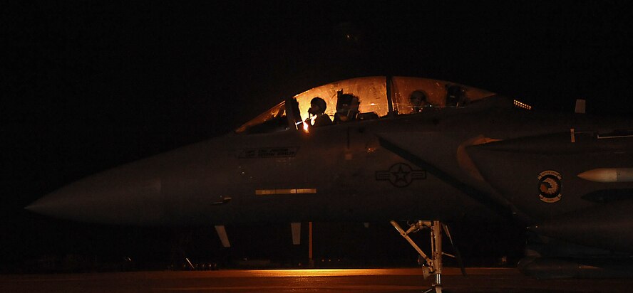 Maj. Frank Fryar, F-15E Strike Eagle pilot, and Capt. Kyle Meyer, weapons systems officer, both with the 335th Fighter Squadron, Seymour Johnson Air Force Base, N.C., wait to taxi to the runway during the early morning on Barksdale Air Force Base, La., Oct. 19. The F-15E Strike Eagle is a dual-role fighter designed to perform air-to-air and air-to-ground missions. An array of avionics and electronics systems gives the F-15 the capability to fly at low altitude, day or night, and in all weather. (U.S. Air Force photo/Senior Airman Kristin High)(RELEASED)
