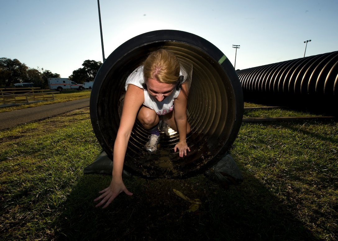 U.S. Air Force Master Sergeant Sonia Poulin, first sergeant of  1st Special Operations Comptroller Squadron, crawls through a tube filled with rotten food during the Carnivore Confidence Course at Hurlburt Field, Fla., Oct. 19, 2012. MSgt. Poulin is in one of many teams participating in the morale building exercise. (U.S. Air Force Photo/ Airman 1st Class Nigel Sandridge)