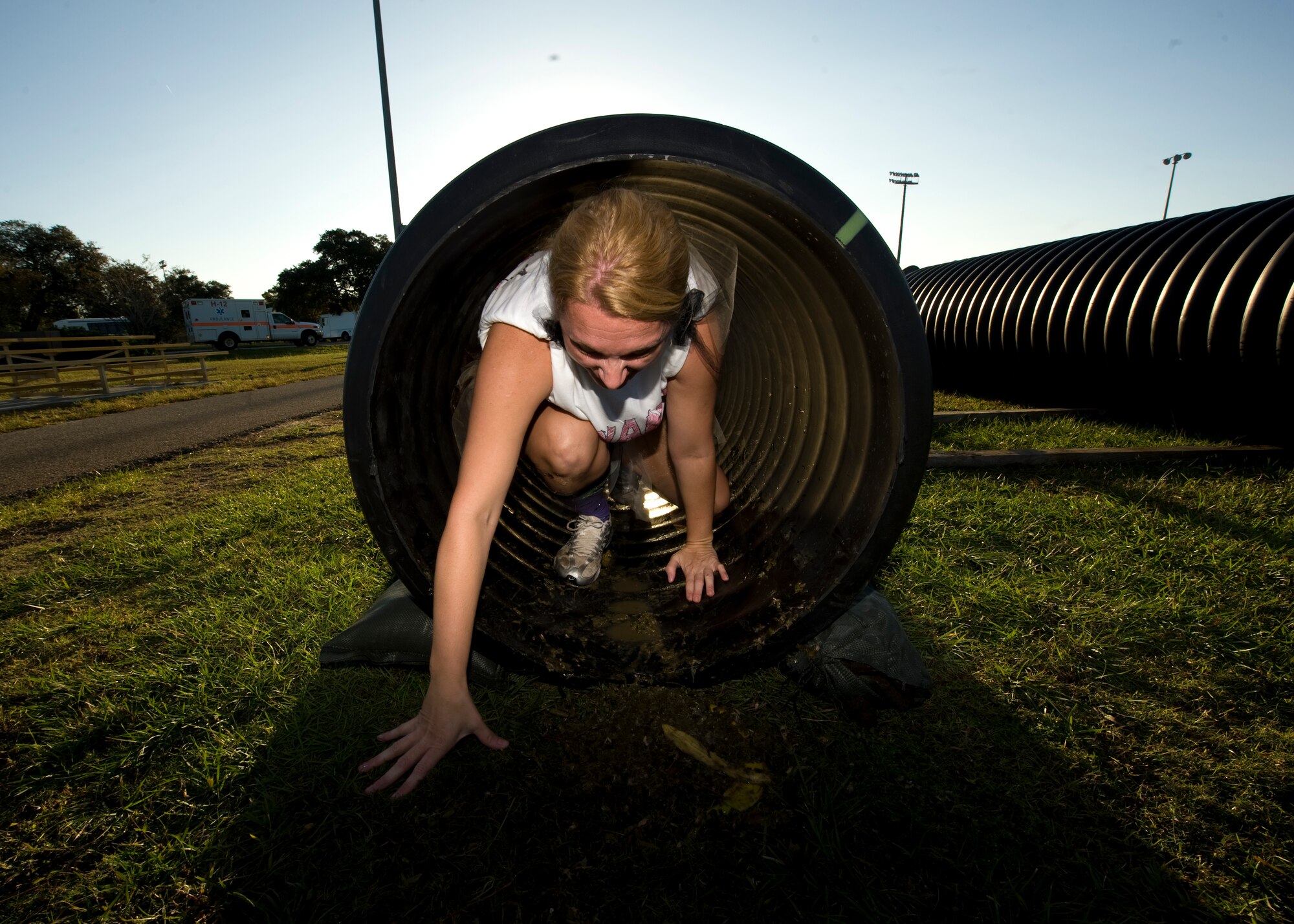 U.S. Air Force Master Sergeant Sonia Poulin, first sergeant of  1st Special Operations Comptroller Squadron, crawls through a tube filled with rotten food during the Carnivore Confidence Course at Hurlburt Field, Fla., Oct. 19, 2012. MSgt. Poulin is in one of many teams participating in the morale building exercise. (U.S. Air Force Photo/ Airman 1st Class Nigel Sandridge)
