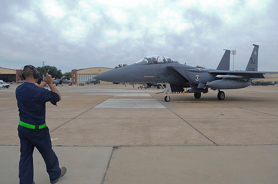 Senior Airman Lawrence McGregor, crew chief, taxis Maj. Thomas Bean, F-15E Strike Eagle pilot, and Capt. Matthew Dvorsky, weapons systems officer, all with the 335th Fighter Squadron, Seymour Johnson Air Force Base, N.C., to the runway on Barksdale Air Force Base, La., Oct. 16. Airmen from Seymour Johnson and soldiers from the  82nd Airborne Division at Fort Bragg, N.C., are here to participate in Green Flag East. Green Flag East  is a joint operation to help service members train for missions during future deployments. (U.S. Air Force photo/Senior Airman Kristin High)(RELEASED)
