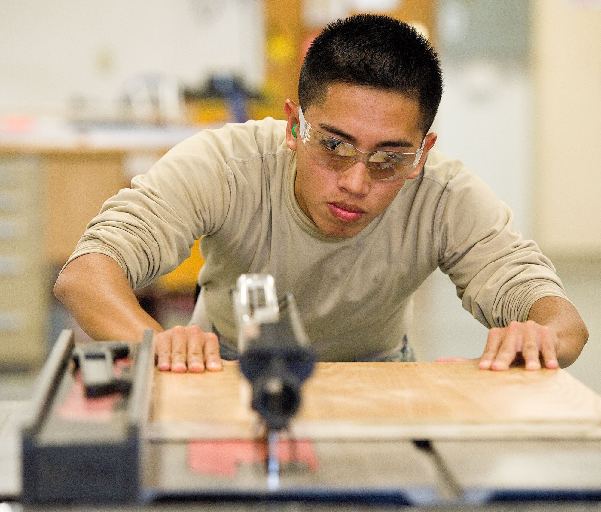Airman 1st Class Aldrin Alarcon, with the 436th Civil Engineering Squadron, cuts a piece of wood October 19, 2012, at Dover Air Force Base, Del. Alarcon was selected as Airman of the Week for the October 26, 2012 edition of The Airlifter. (U.S. Air Force photo/Roland Balik)