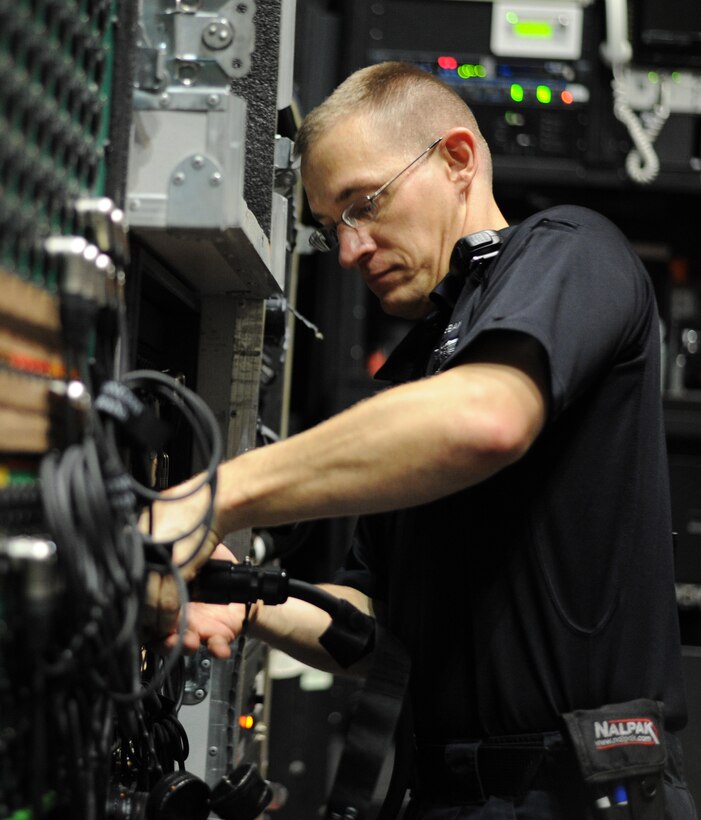 Master Sgt. Mark Hannah, U.S. Air Force Concert Band audio engineer, sets up the sound system before a concert during the U.S. Air Force Concert Band and Singing Sergeants 2012 Fall Tour at the San Luis Obispo Performing Arts Center in San Luis Obispo, Calif., Oct. 15, 2012. (U.S. Air Force photo/ Staff Sgt. Keyonna Fennell)
