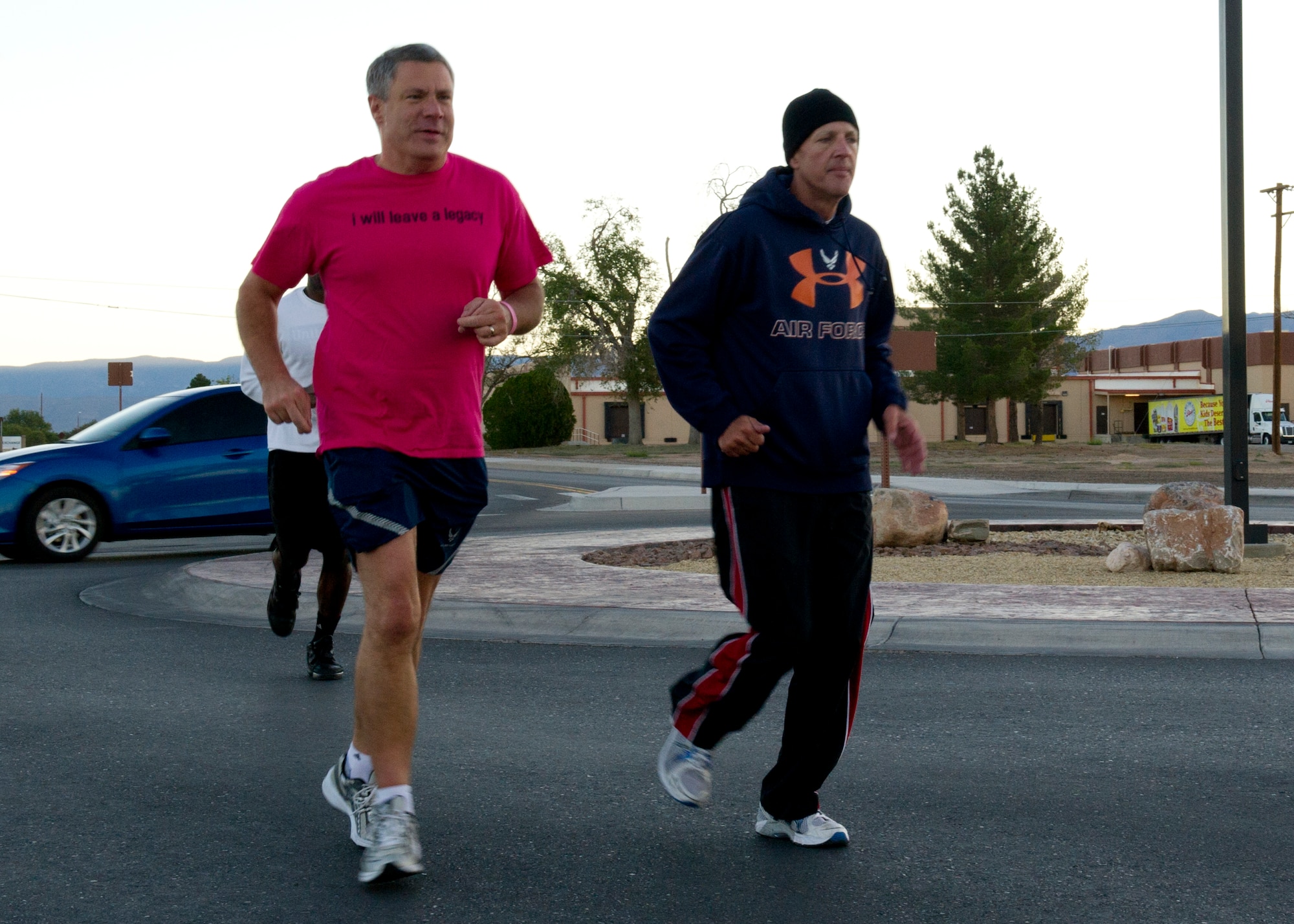 Colonel Kevin Bennett, 49th Mission Support Group commander, and Col. James Krajewski, 49th Materiel Maintenance Group commander, run during a 5k run/walk for breast cancer awareness at Holloman Air Force Base, N.M., Oct. 19. October is National Breast Cancer Awareness Month, which is an annual campaign to increase awareness of the disease. (U.S. Air Force photo by Senior Airman Kasey Close/Released)
