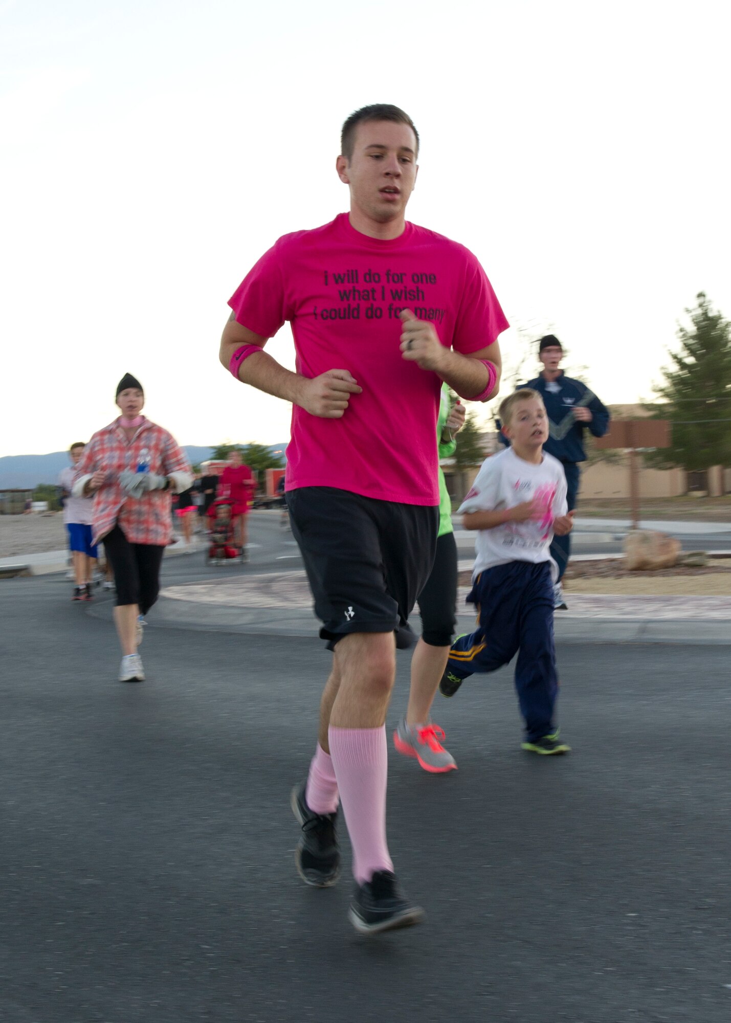 A member of Team Holloman participates in a 5k run/walk for breast cancer awareness at Holloman Air Force Base, N.M., Oct. 19. The run was sponsored by the 49th Medical Group’s Health and Wellness Center and Women’s Health Clinic. (U.S. Air Force photo by Senior Airman Kasey Close/Released)