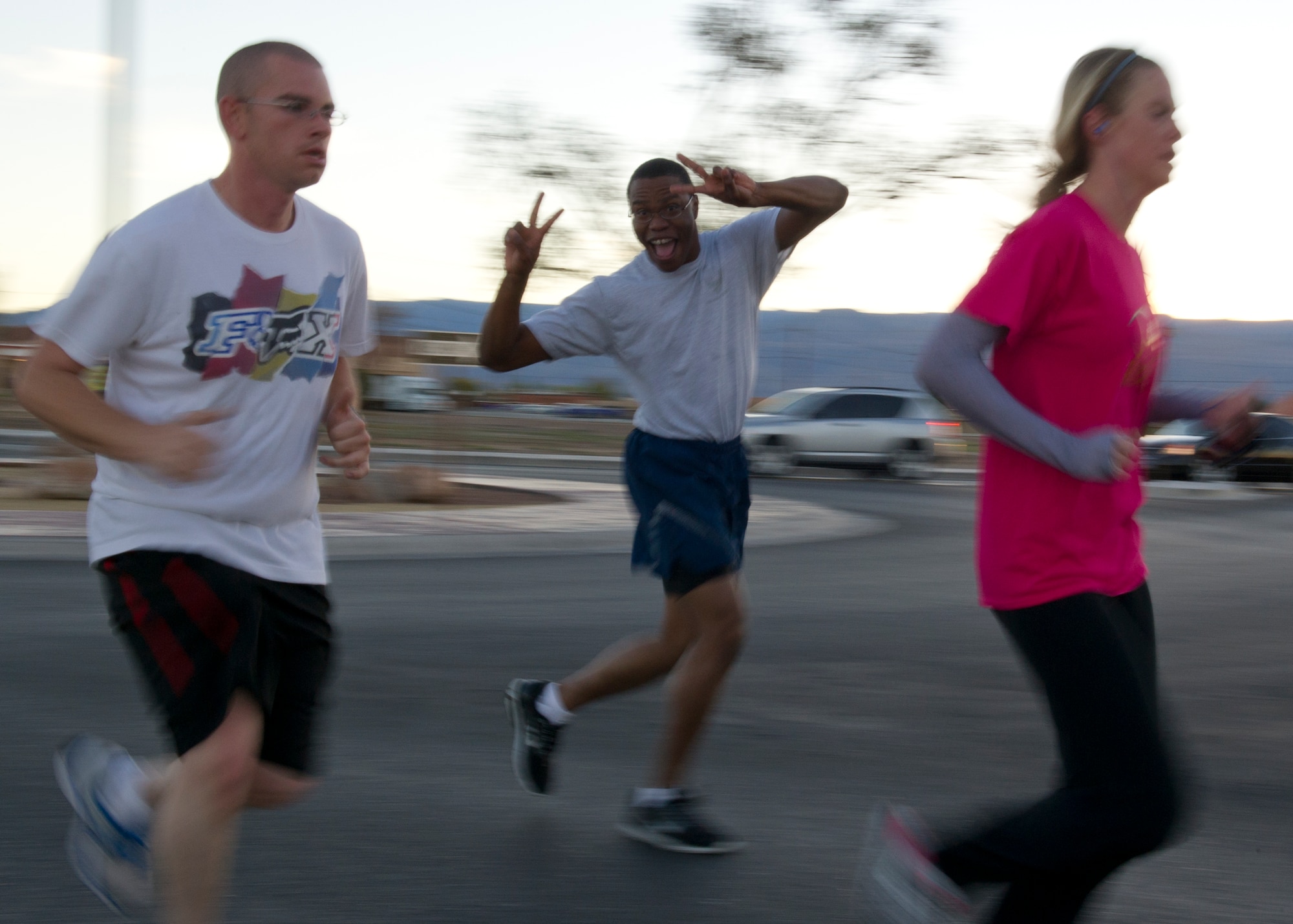 Senior Airman Michael Adams, 49th Comptroller Squadron financial and comptroller journeyman, gives the peace sign during a 5k run/walk for breast cancer awareness at Holloman Air Force Base, N.M., Oct. 19. October is National Breast Cancer Awareness Month, which is an annual campaign to increase awareness of the disease. (U.S. Air Force photo by Senior Airman Kasey Close/Released)