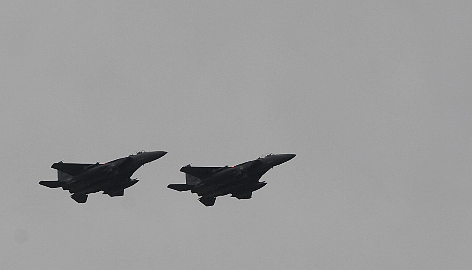 Two F-15E Strike Eagles from the 335th Fighter Squadron, Seymour Johnson AFB, N.C., fly in formation above Barksdale Air Force Base, La., Oct. 16. The F-15E Strike Eagle is a dual-role fighter designed to perform air-to-air and air-to-ground missions. An array of avionics and electronics systems gives the F-15E the capability to fight at low altitude, day or night, and in all weather. The aircraft uses two crew members, a pilot and a weapon systems officer. More than 160 Airmen and 12 F-15E Strike Eagles from Seymour Johnson AFB, N.C., are at Barksdale for joint training with the 82nd Airborne Division, Fort Bragg, N.C., during Green Flag East. (U.S. Air Force photo/Senior Airman Kristin High)(RELEASED)
