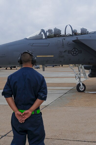 Maj. Thomas Bean, F-15E Strike Eagle pilot, signals Senior Airman Lawrence McGregor, crew chief, both with the 335th Fighter Squadron, Seymour Johnson Air Force Base, N.C., that the aircraft is ready to launch on Barksdale Air Force Base, La., Oct. 16. More than 160 Airmen and 12 F-15E Strike Eagles from Seymour Johnson are at Barksdale for joint training with the 82nd Airborne Division, Fort Bragg, N.C., during Green Flag East. The F-15E Strike Eagle is a dual-role fighter designed to perform air-to-air and air-to-ground missions. An array of avionics and electronics systems gives the F-15E the capability to fight at low altitude, day or night, and in all weather. (U.S. Air Force photo/Senior Airman Kristin High)(RELEASED)
