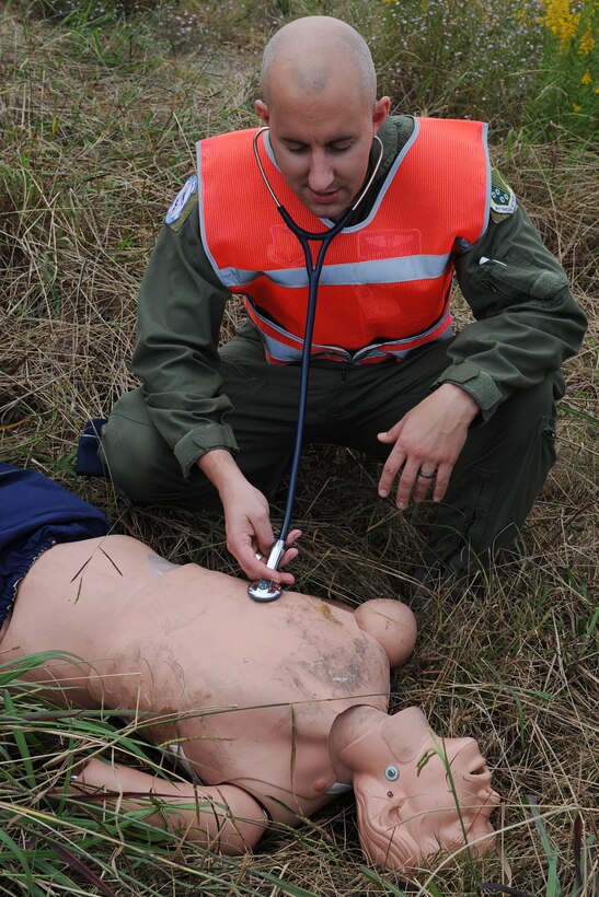 U.S. Air Force Maj. Lance “Nightmare” Black, 94th Fighter Squadron flight surgeon, checks a simulated casualty for a pulse during a major accident response exercise at Langley Air Force Base, Va., Oct. 19, 2012. First-responders participated in the exercise to evaluate how well personnel react to major accidents. (U.S. Air Force photo by Staff Sgt. Ashley Hawkins/Released)
