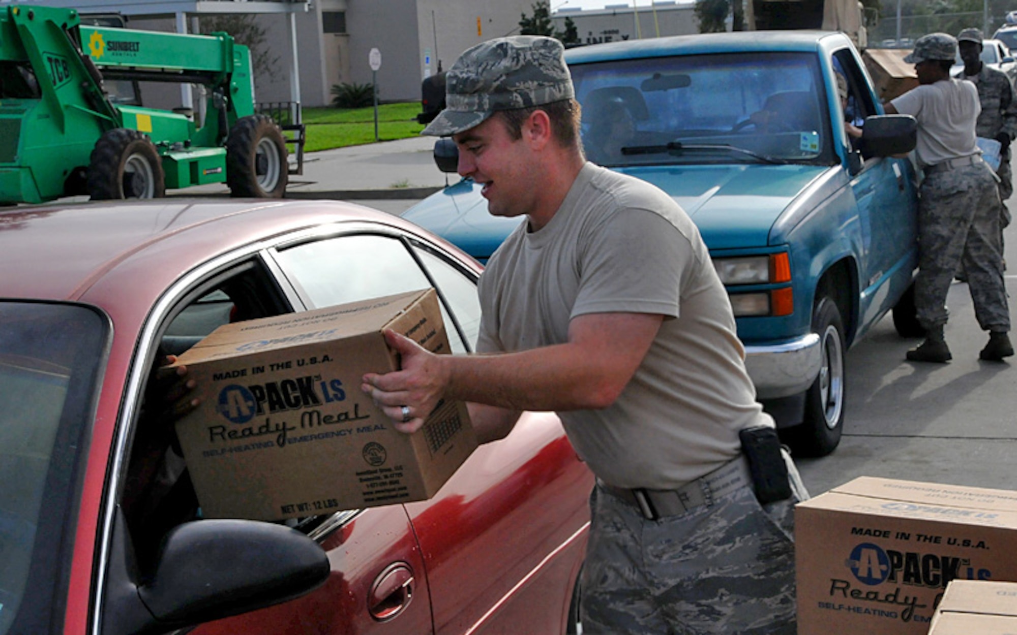 Members the 159th Fighter Wing, Louisiana Air National Guard, distribute meals, water and ice to local residents processing through a commodities distribution site in the aftermath of Hurricane Isaac in Harvey, La., Aug. 31, 2012. The state activated more than 7,000 Louisiana Guardsmen to assist area residents along with local and state authorities in support of Hurricane Isaac relief. (U.S. Air Force photo by Master Sgt. Dan Farrell/RELEASED)