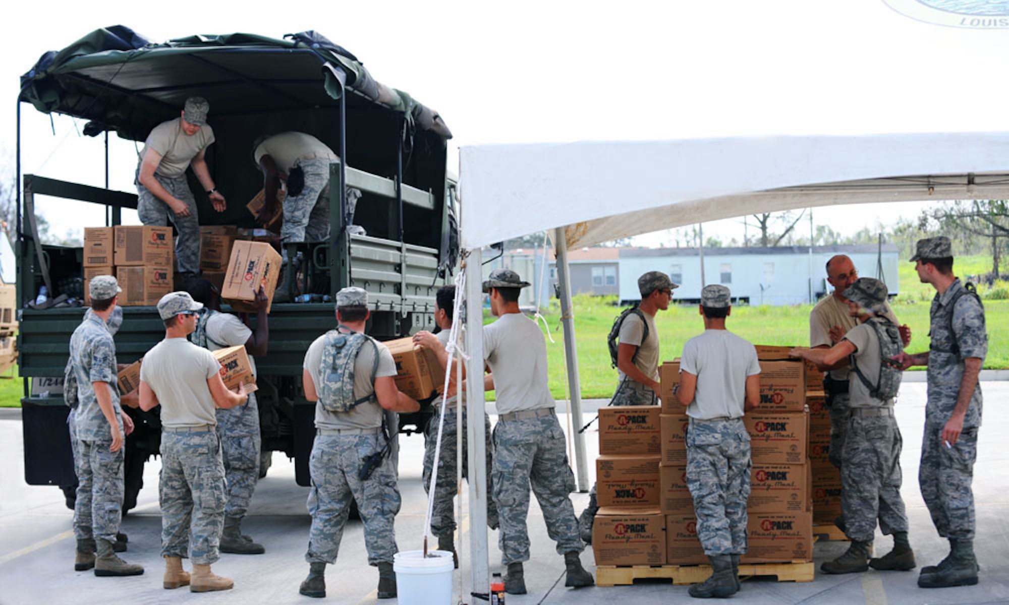 Members of the 159th Fighter Wing, Louisiana Air National Guard, work at a point of distribution site Sept. 6, 2012, in Davant, La. These distributions sites were established during the aftermath of Hurricane Isaac to assist residents in of food, water, ice, tarps and other needed supplies. (U.S. Air Force photo by Master Sgt. Dan Farrell/RELEASED)