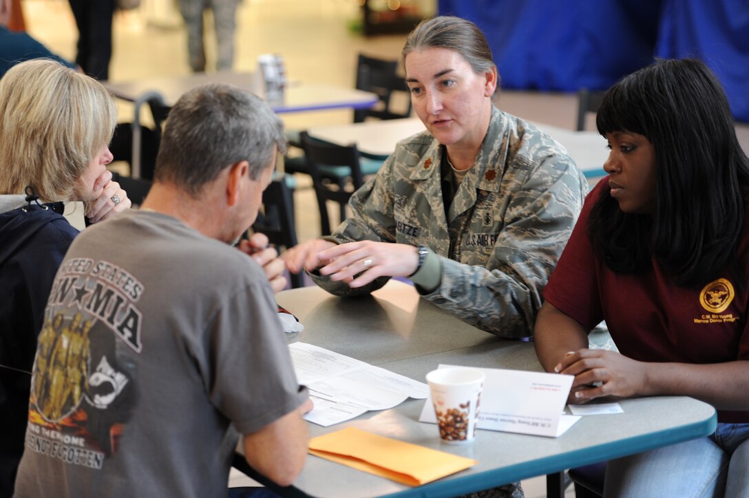 Maj. Rachelle Hartze, 28th Medical Operations Squadron Aerospace Medicine Flight commander, helps Airmen and their families complete registration forms to donate bone marrow during a Department of Defense Bone Marrow Donor Program registration drive in the Exchange lobby at Ellsworth Air Force Base, S.D., Oct. 15, 2012. There are currently more than 30,000 children and adults in the U.S. suffering from diseases who can benefit from a marrow transplant. (U.S. Air Force photo by Airman 1st Class Hrair H. Palyan/Released)