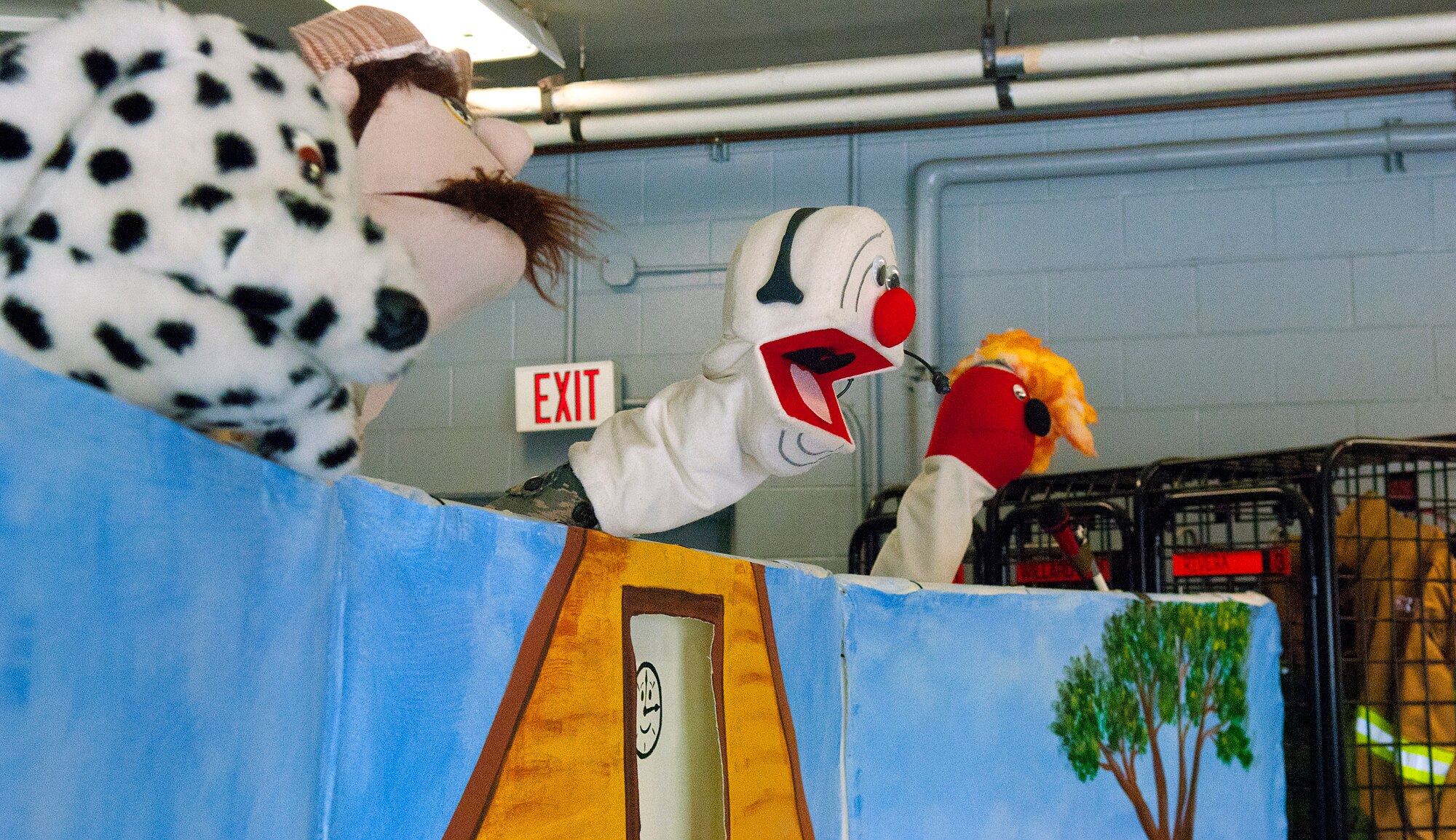 Firefighters with the 90th Civil Engineer Squadron use puppets to teach fire safety Oct. 13 during a Fire Prevention Week open house and fall festival co-sponsored by the 90 CES and Balfour Beatty Communities. (U.S. Air Force photo by R.J. Oriez)