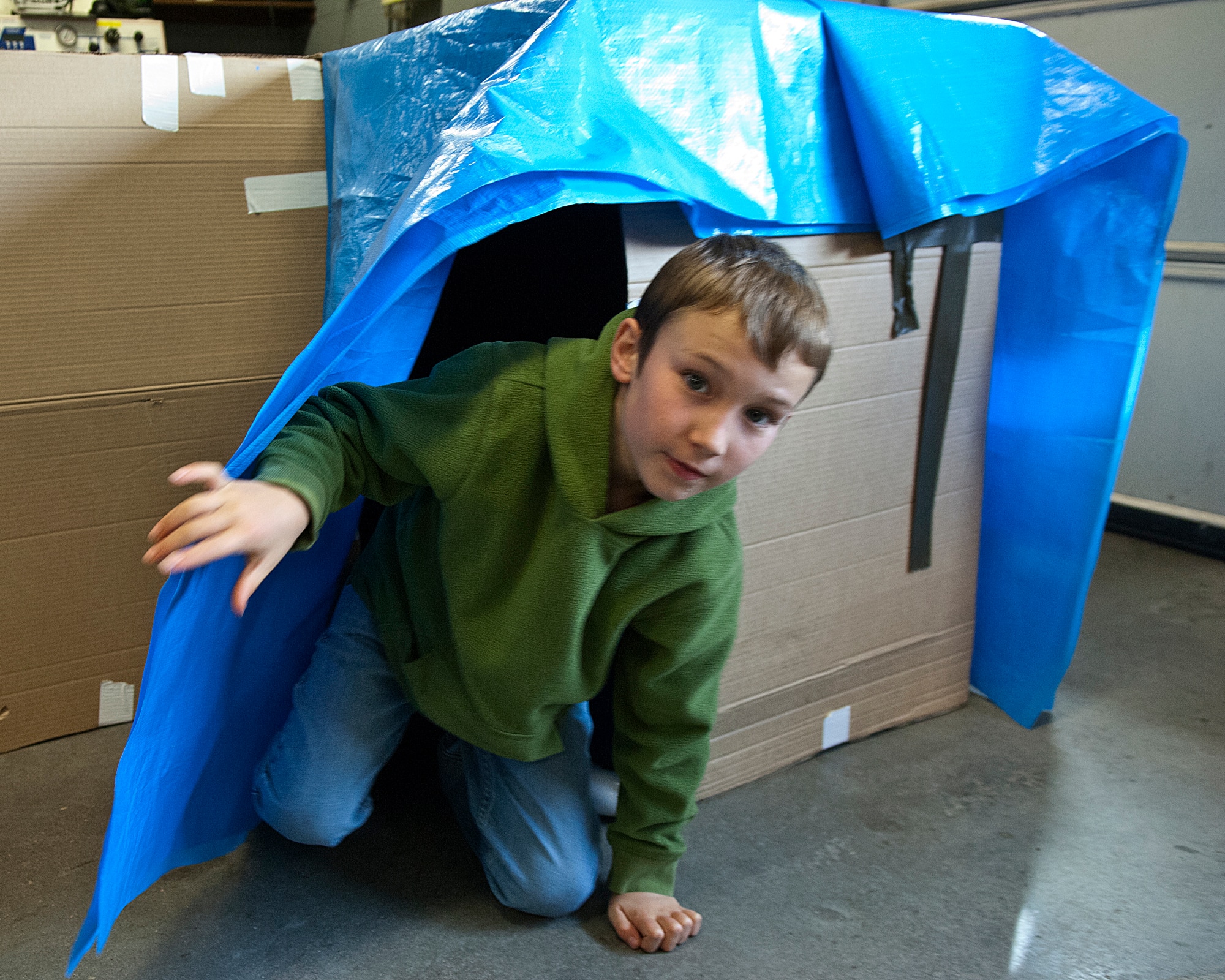 Alex Brunner, 8, comes out of a cardboard tunnel Oct. 13, which was set up as part of a Fire Prevention Week open house and fall festival co-sponsored by the 90th Civil Engineer Squadron and Balfour Beatty Communities on F. E. Warren Air Force Base, Wyo. Brunner is the son of Lijane Brunner, 90th CES. (U.S. Air Force photo by R.J. Oriez)