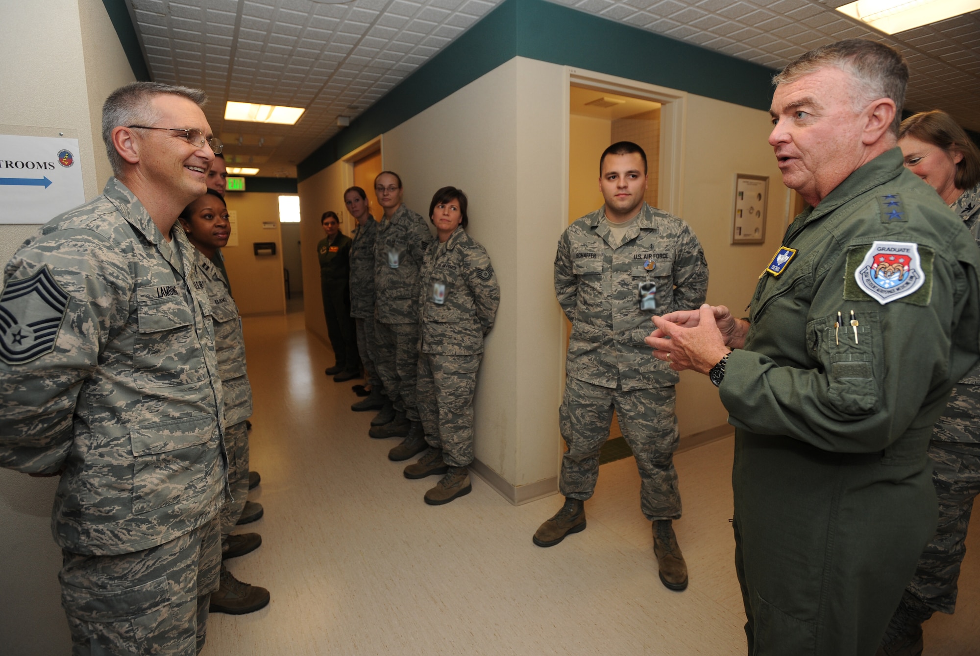 MINOT AIR FORCE BASE, N.D. -- Lt. Gen. Thomas W. Travis, U.S. Air Force Surgeon General and Chief Master Sgt. Kevin Lambing, Chief, Medical Enlisted Force, meet with members of the 5th Medical Group's Flight Medicine to discuss unit readiness and bring to light any intricacies in their duties, Oct. 5. During his visit to Minot, the surgeon general learned about the complexities of the Personnel Reliability Program mission which involve more than 3,300 members here. He also had the opportunity to visit Airmen throughout the various units at the 5th MDG and learn about the mission they execute on a daily basis at Minot Air Force Base. (U.S. Air Force photo/Senior Airman Jose L. Hernandez) 