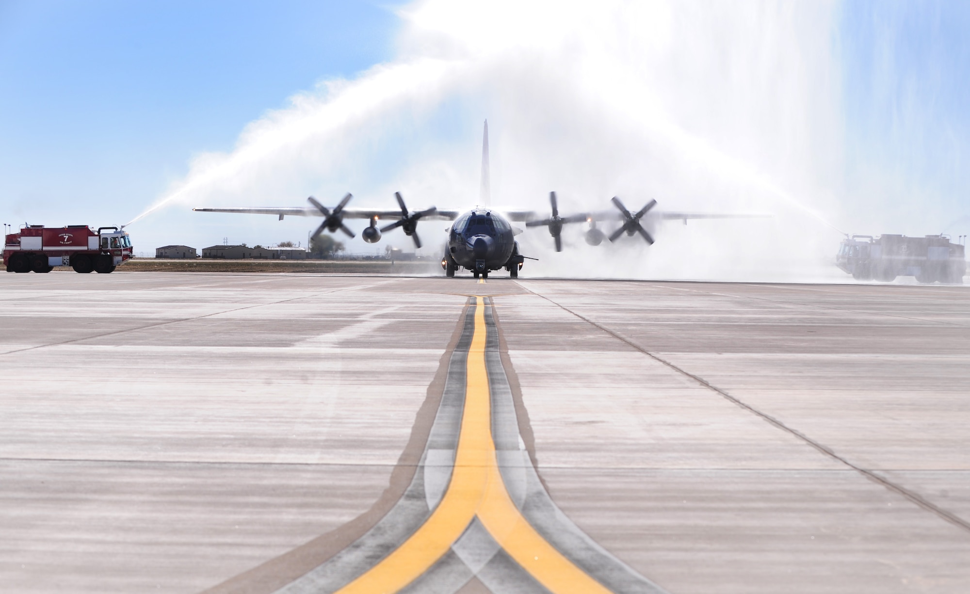 An AC-130W Stinger II, 73rd Special Operations Squadron, is sprayed by fire trucks while taxing down a newly opened flightline taxiway addition at Cannon Air Force Base, N.M., Oct. 19, 2012. The flightline taxiway is part of the new additions being added to Cannon and will be used to park up to 18 additional aircraft that will be grafted into the Cannon fleet sometime in the next three years. (U.S. Air Force photo/Airman 1st Class Ericka Engblom)