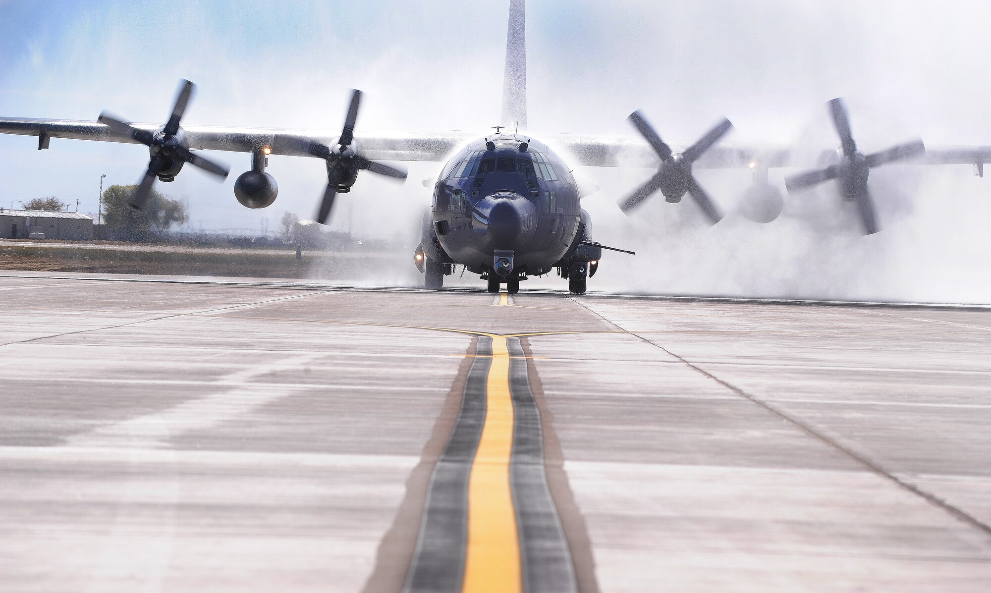 An AC-130W Stinger II, 73rd Special Operations Squadron, rolls through a stream of water, down a newly opened flightline taxiway addition at Cannon Air Force Base, N.M., Oct. 19, 2012. The flightline taxiway is part of the new additions being added to Cannon and will be used to park up to 18 additional aircraft that will be grafted into the Cannon fleet sometime in the next three years. (U.S. Air Force photo/Airman 1st Class Ericka Engblom)