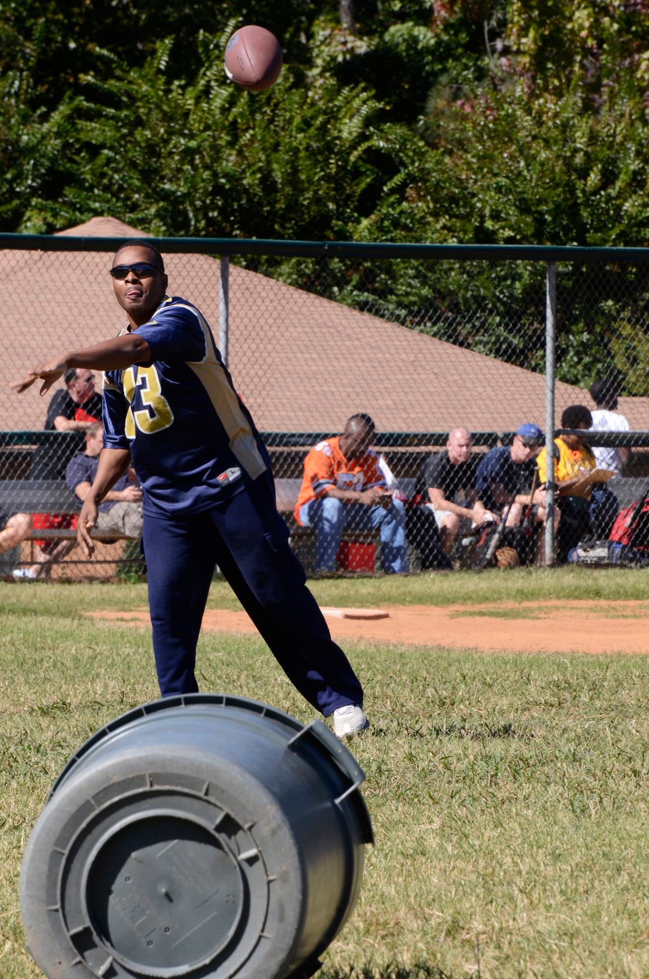 Staff Sgt Johnny L. Glenn from the 94th Operations Support Squadron competes in the football toss attempting to pass a football into a trash container, just one of 15 events during the Annual 94th Airlift Wing Team Day held at Dobbins Air Reserve Base, Ga., Oct. 16. Team day is designed to promote team work and competitive spirit between units. (U.S. Air Force photo/Don Peek)