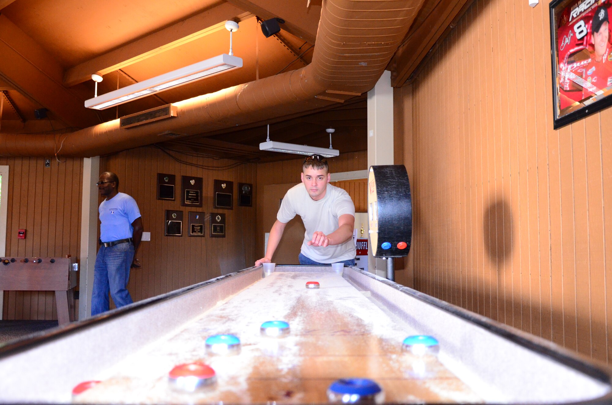 Teams compete in shuffleboard as one of 15 events at the Annual 94th Airlift Wing Team Day at Dobbins Air Reserve Base, Ga., Oct. 16. Team day is designed to promote team work and competitive spirit between units. (U.S. Air Force photo/ Senior Airman Elizabeth Van Patten)