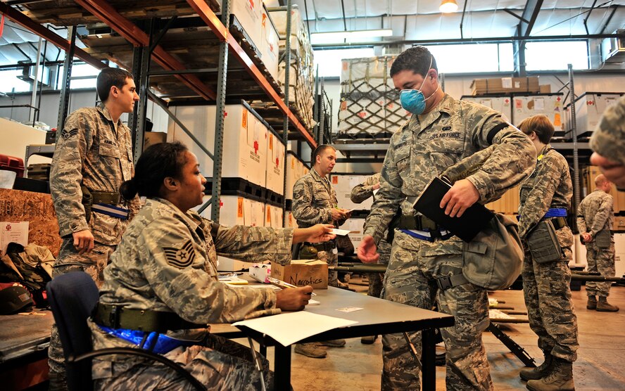 375th Medical Group personnel process patients who have flu-like symptoms during an operational readiness exercise at Scott Air Force Base, Ill. Oct. 17. The 375th Air Mobility Wing is participating in an exercise designed to test their ability to survive and operate in a hostile or chemical environment. The wing is preparing for their combined operational readiness inspection next year. (U.S. Air Force photo/ Staff Sgt. Ryan Crane)