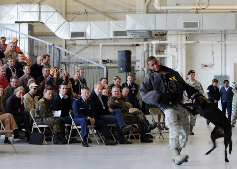 The 11th Security Forces Squadron Military Working Dog section performs for personnel from the Embassy of the Federal Republic of Germany in Washington D.C., during a tour of Joint Base Andrews, Md., Oct. 17, 2012. Andrews is home to the Department of Defense's largest MWD section and houses more than 30 working dogs. (U.S. Air Force photo/ Staff Sgt. Nichelle Anderson)(Released)
