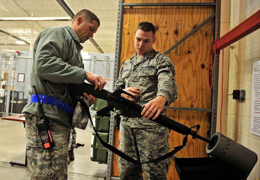 Staff Sgt. Justin Schichler, 375th Logistics Readiness Squadron, acts as the armorer during an operational readiness exercise at Scott Air Force Base, Ill. Oct. 16. The 375th Air Mobility Wing is participating in an exercise designed to test their ability to survive and operate in a hostile or chemical environment. The wing is preparing for their combined operational readiness inspection next year. (U.S. Air Force photo/ Staff Sgt. Ryan Crane)