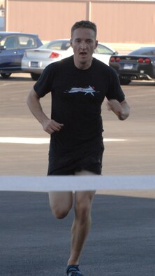 Capt. Riley Hestermann, 34th Aircraft Maintenance Unit officer in charge, crosses the finish line during the Breast Cancer Awareness 5k at Ellsworth Air Force Base, S.D., on Oct. 12, 2012. More than 215 Airmen and their families and coworkers participated in the run/walk conducted to bolster awareness for breast cancer. (U.S. Air Force photo by Airman 1st Class Audra M. Hornbacher)