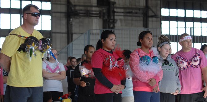Participants of the Breast Cancer Awareness 5k gather around the stage, sporting their personally decorated bras, while listening to the personal experiences of a breast cancer survivor prior to race start at the Pride Hangar, at Ellsworth Air Force Base, S.D. on Oct. 12, 2012. Contestants were given the option to decorate flamboyant bras and compete for prizes, giving the serious disease a fun and light-hearted activity to foster awareness. (U.S. Air Force photo by Airman 1st Class Audra M. Hornbacher)