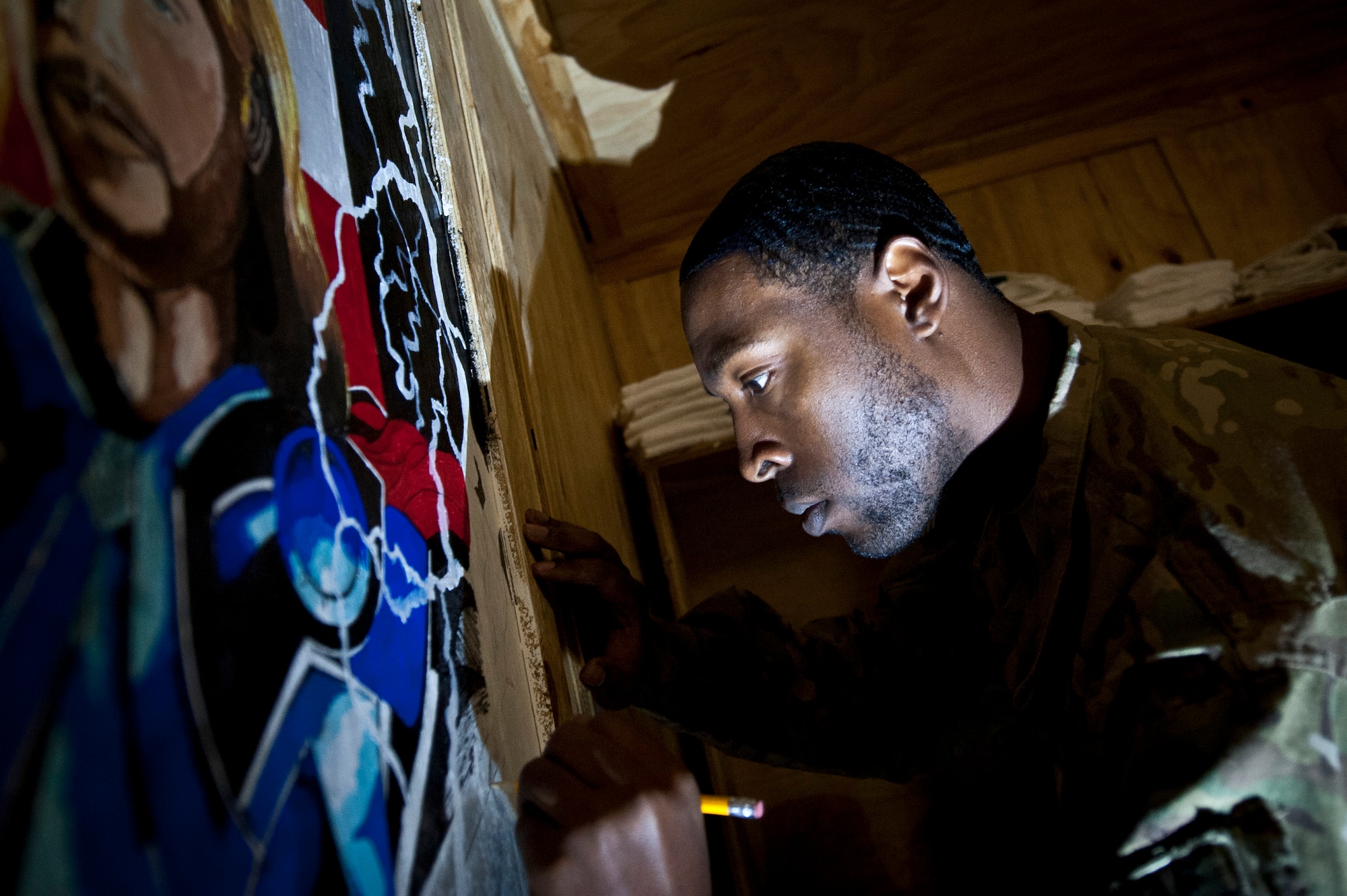 Staff Sgt. William Beal, an Airman assigned to 455th Expeditionary Logistics Readiness Squadron, paints an "Avengers"-themed mural on the wall of the “Airman’s Attic” at Bagram Airfield, Afghanistan, Oct. 19, 2012. Beal volunteered his time and artistic talent to the Attic in order to add this special detail to the building. (U.S. Air Force Photo/Capt. Raymond Geoffroy)