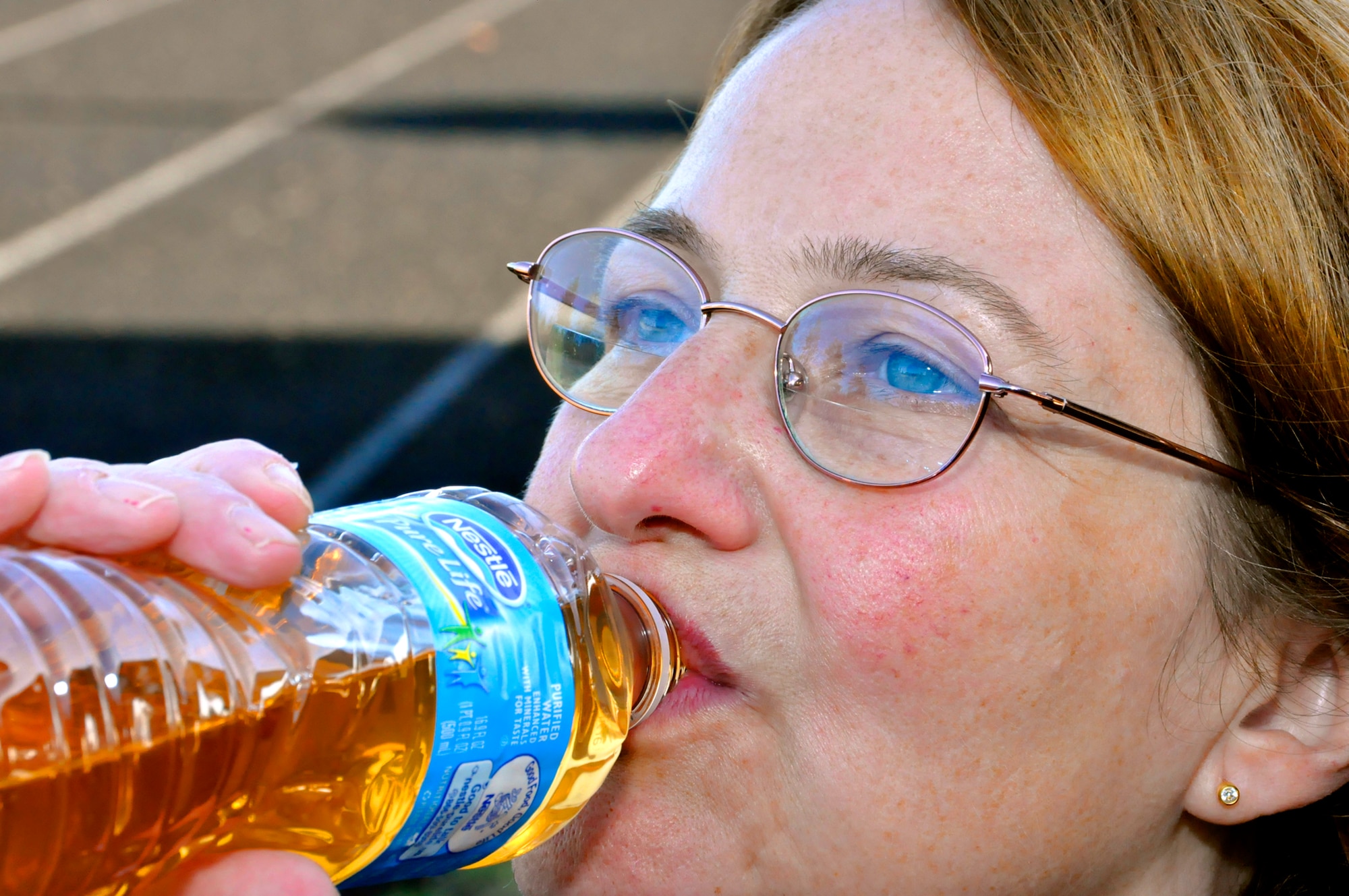 Maj. Maryjane Baska, a Reservist with the 446th Aeromedical Squadron, hydrates with flavored water during her fitness assessment on McChord Field's track Oct. 16. Cold weather exercise still requires the same amount of water intake as warm weather physical training. (U.S. Air Force photo/Staff Sgt. Rachael Garneau)