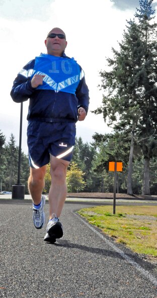 Tech Sgt. James Hoole, a Reservist with the 313th Airlift Squadron, runs on McChord Field's track for his fitness assessment Oct. 16. According the base's Fitness Assessment Cell, airmen should wear layers to their PT test to allow for their body temperature rising after the warm-up exercises. (U.S. Air Force photo/Staff Sgt. Rachael Garneau)