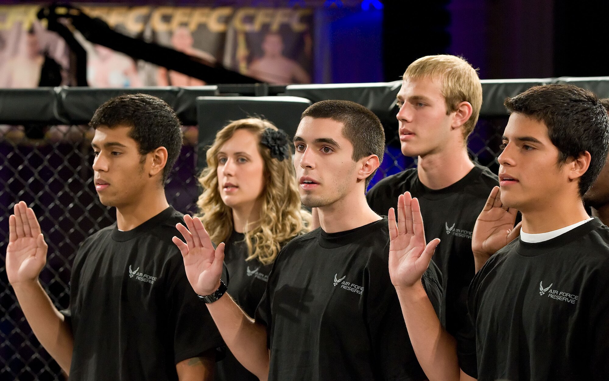 Pictured are five of 12 Delaware recruits reciting the oath of enlistment Oct. 13, 2012, during the intermission of a mixed martial arts event at the Rollins Center in Dover, Del. The new recruits will attend Basic Military Training alongside active-duty Airmen in Texas and will be assigned to the 512th Airlift Wing at Dover Air Force Base, Del.  (U.S. Air Force photo/Roland Balik)
