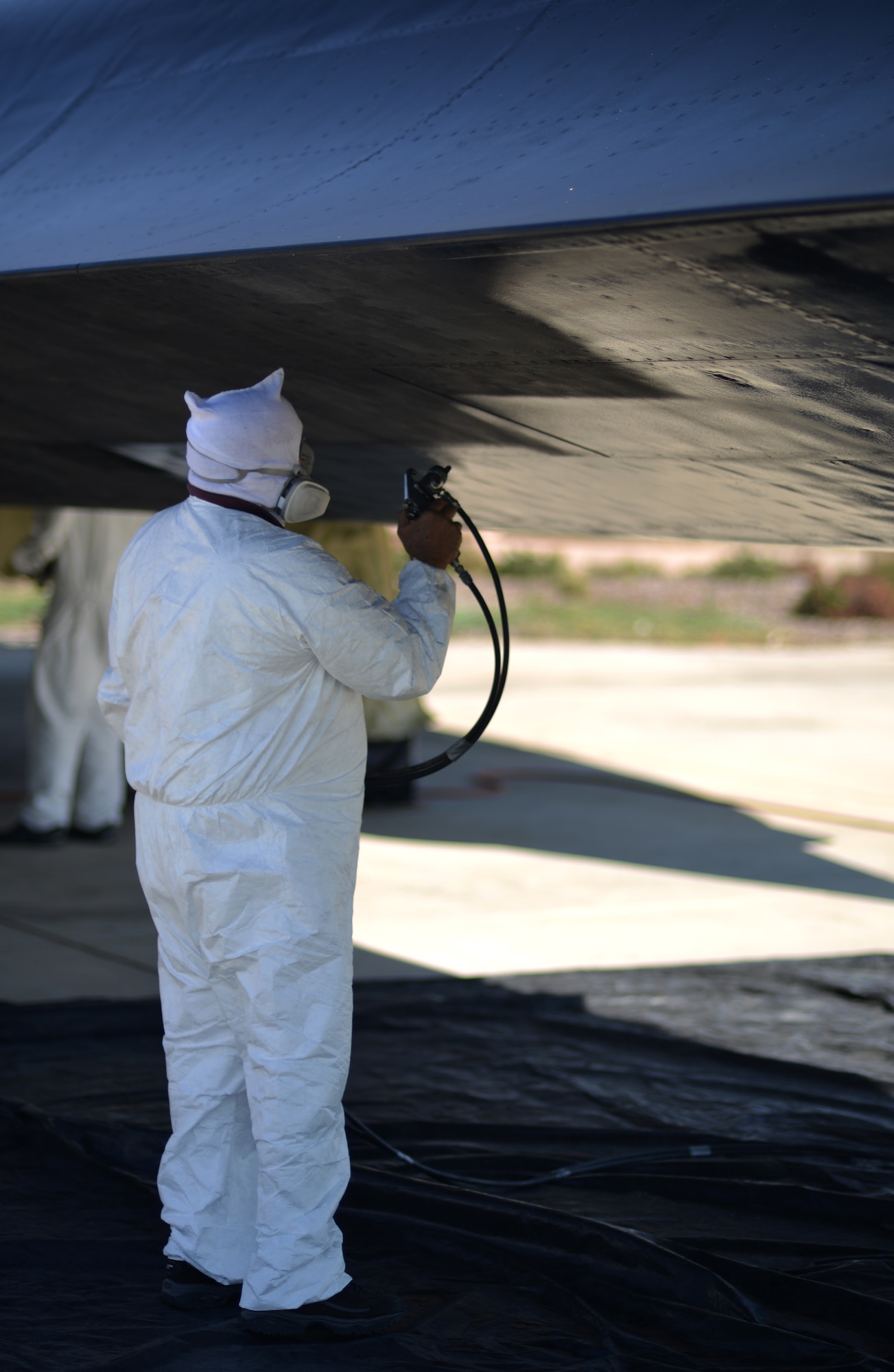 Rick Ashcraft paints the SR-71 Blackbird static display at Heritage Park, Beale Air Force Base, Calif., Sept. 29, 2012. The Blackbird was a high-speed, high-altitude reconnaissance aircraft that served the Air Force from 1964 to 1998. (U.S. Air Force photo by Airman 1st Class Andrew Buchanan)