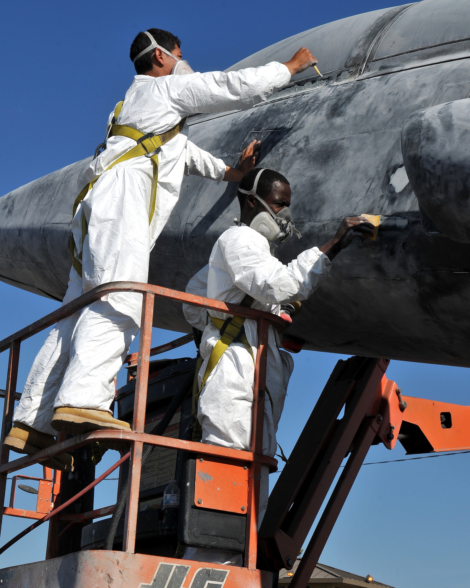 Employees of a Texas based company smooth putty onto imperfections before applying primer to a T-38 Talon static display at Beale Air Force Base, Calif., Oct. 14, 2012. The T-38 Talon is a twin engine supersonic jet trainer aircraft used at Beale to train U-2 Dragon lady pilots. (U.S. Air Force photo by Senior Airman Rebeccah Anderson/Released)