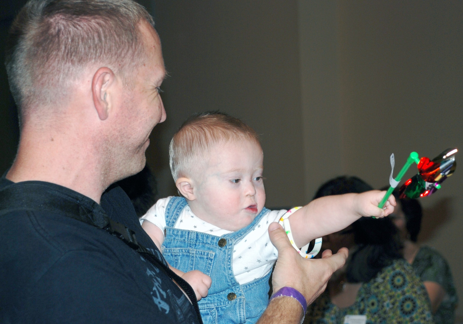 Eighteen-month-old Cullen Turner enjoyed his pinwheel while his dad, Sgt. Tim Turner from the San Antonio Military Medical Center, browsed the vendor’s literature and brochures at the Oct. 13 EFMP Resource Fair and Child Find Event at Morgan’s Wonderland. (Photo by Cheryl Harrison, JBSA-Fort Sam Houston Warfighter and Family Readiness Marketing)