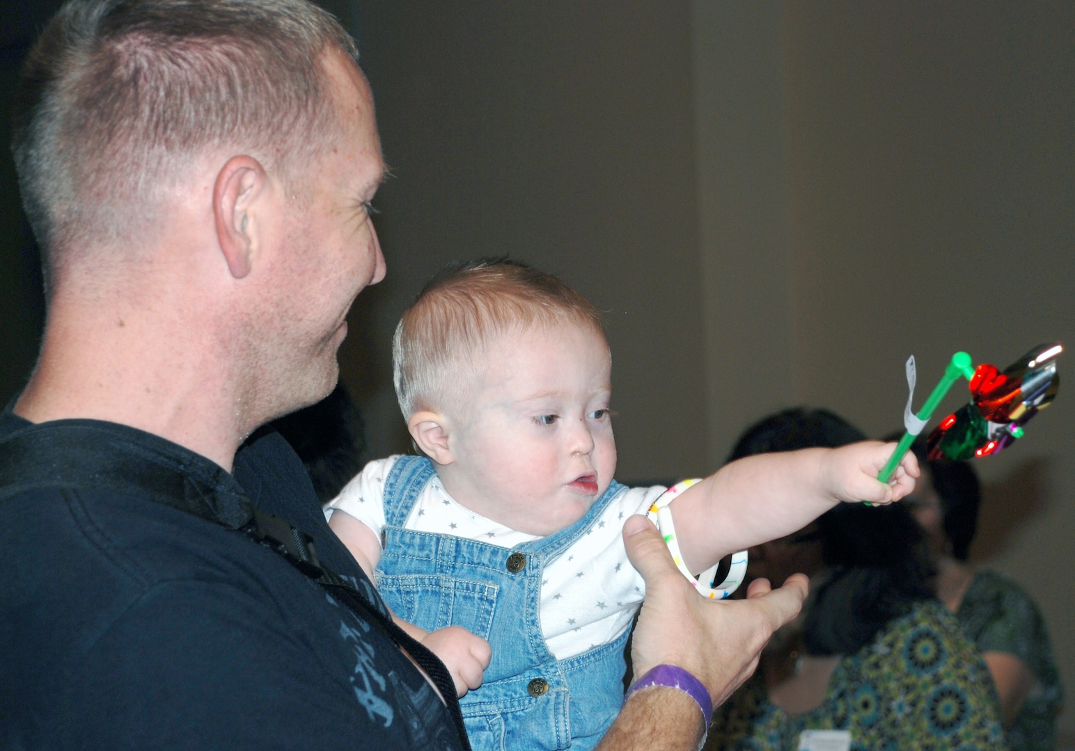 Eighteen-month-old Cullen Turner enjoyed his pinwheel while his dad, Sgt. Tim Turner from the San Antonio Military Medical Center, browsed the vendor’s literature and brochures at the Oct. 13 EFMP Resource Fair and Child Find Event at Morgan’s Wonderland. (Photo by Cheryl Harrison, JBSA-Fort Sam Houston Warfighter and Family Readiness Marketing)