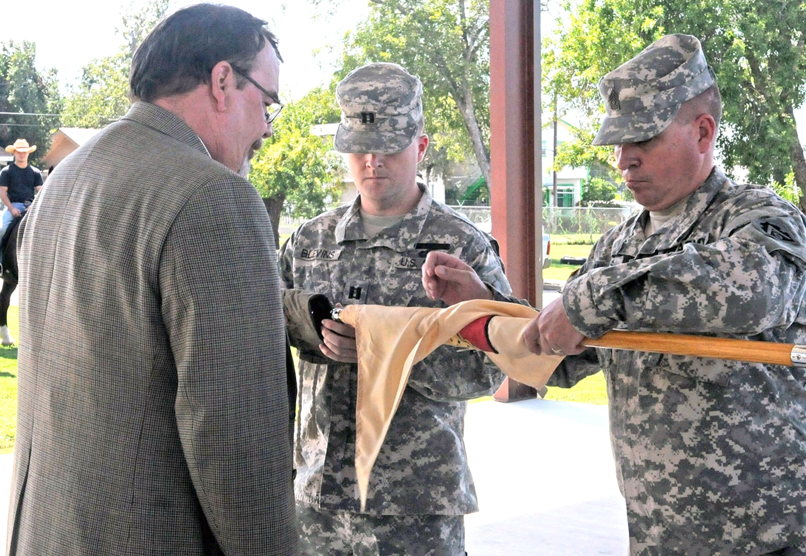 Capt. James Blevins, company commander of Headquarters and Headquarters Company, Army Support Activity, and 1st Sgt. Anthony Walls, case the company guidon during an inactivation ceremony held Oct. 2 as Frank Blakely, ASA manager, looks on. The Military Honors Platoon, which provides military funeral honors in the south Texas region and ceremonial support to JBSA-Fort Sam Houston and the greater San Antonio military community, is now part of Army North’s Headquarters Support Company, Headquarters and Headquarters Battalion. (Photo by Staff Sgt. Corey Baltos, U.S. Army North Public Affairs)