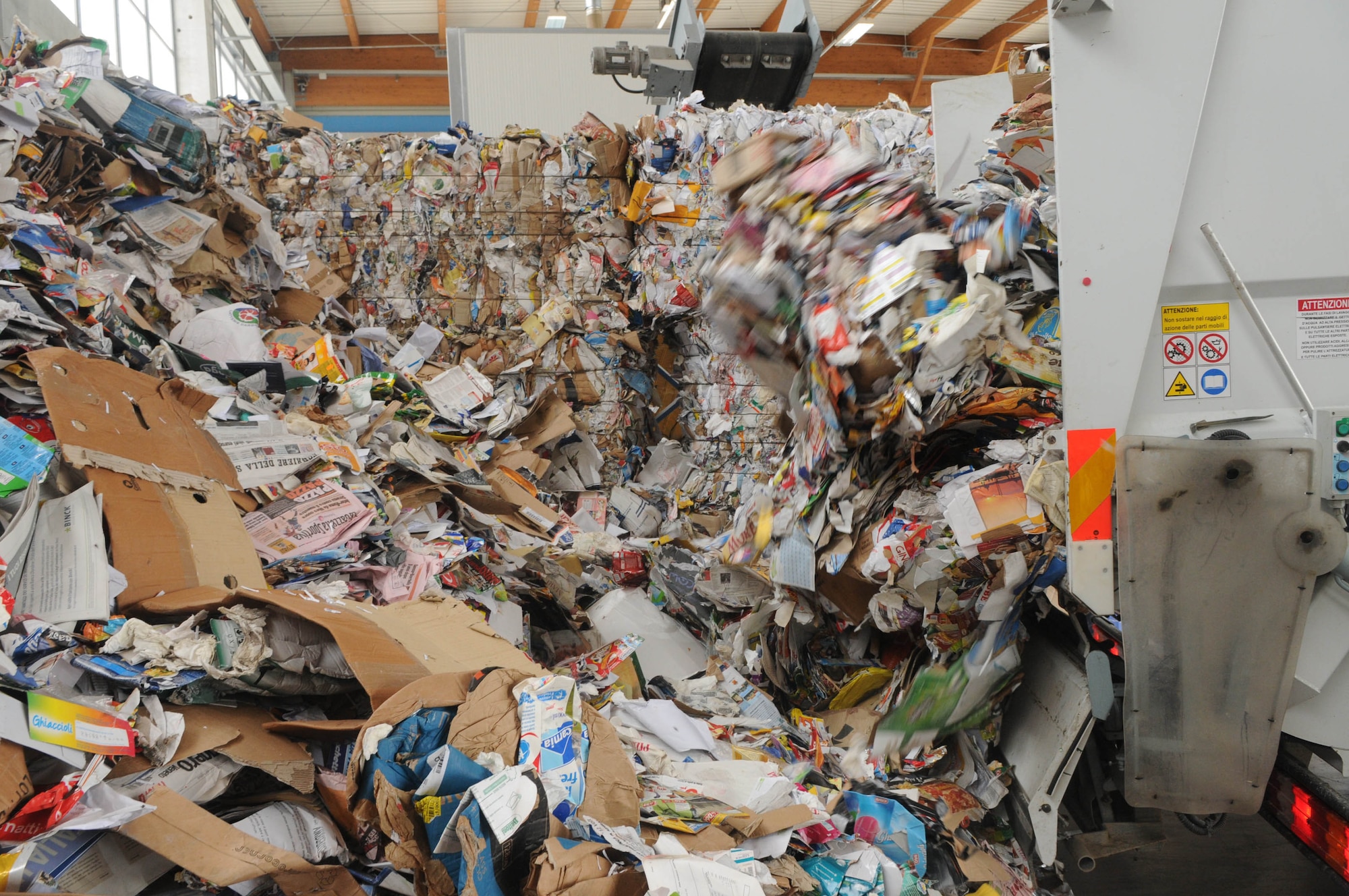 A garbage truck dumps recyclable paper products into a pile at a recycling plant near Aviano Air Base, Sept. 5.There are different types of recyclable materials such as a non-recycling dry waste, wet waste, paper/cardboard, aluminum cans/glass, and plastics. (U.S. Air Force photo/Airman 1st Class Matthew Lotz) 