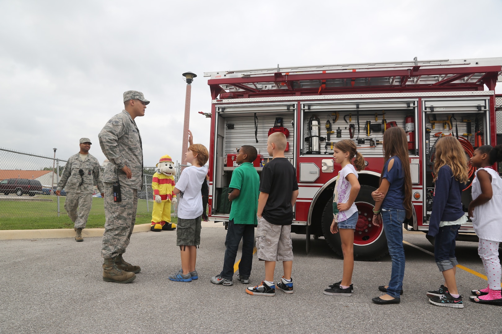 Senior Airman Kiounte Lineberge, 902nd Civil Engineer Squadron Fire Emergency Service B shift driver operator, answers a Randolph Elementary School student’s question about the firefighting engine during the annual Fire Prevention Week demonstration Oct. 10 at Joint Base San Antonio-Randolph.  (U.S. Air Force photo by Josh Rodriguez)