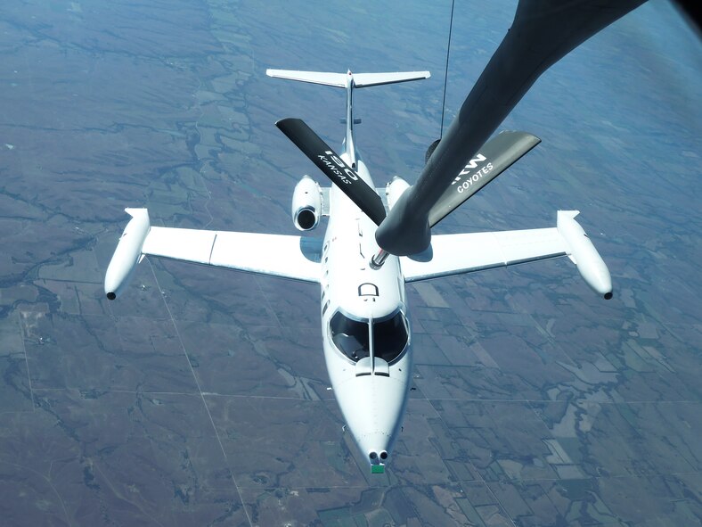 A Learjet, standing in for a Remotely Piloted Aircraft, flies into refueling position during Automated Aerial Refueling flights that tested Precision GPS algorithms and advanced sensors. (AFRL Image)