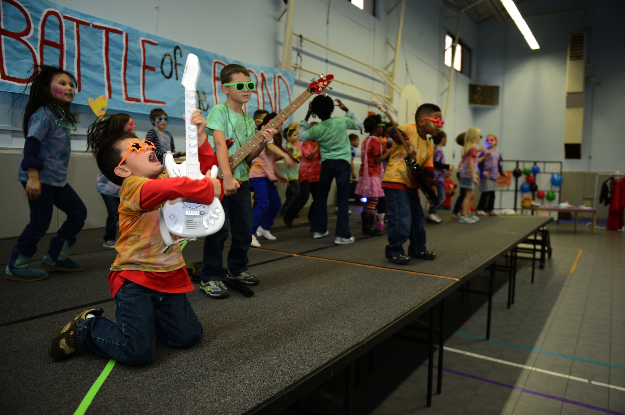 SPANGDAHLEM AIR BASE, Germany – Children perform in a battle of the bands competition at the School Age Program during a Lights On Afterschool event Oct. 18, 2012.  The purpose of the event was to raise awareness of afterschool programs through various activities hosted by the School Age Program, ranging from a battle of the bands to science experiments and face painting. (U.S. Air Force photo by Airman 1st Class Gustavo Castillo/Released)