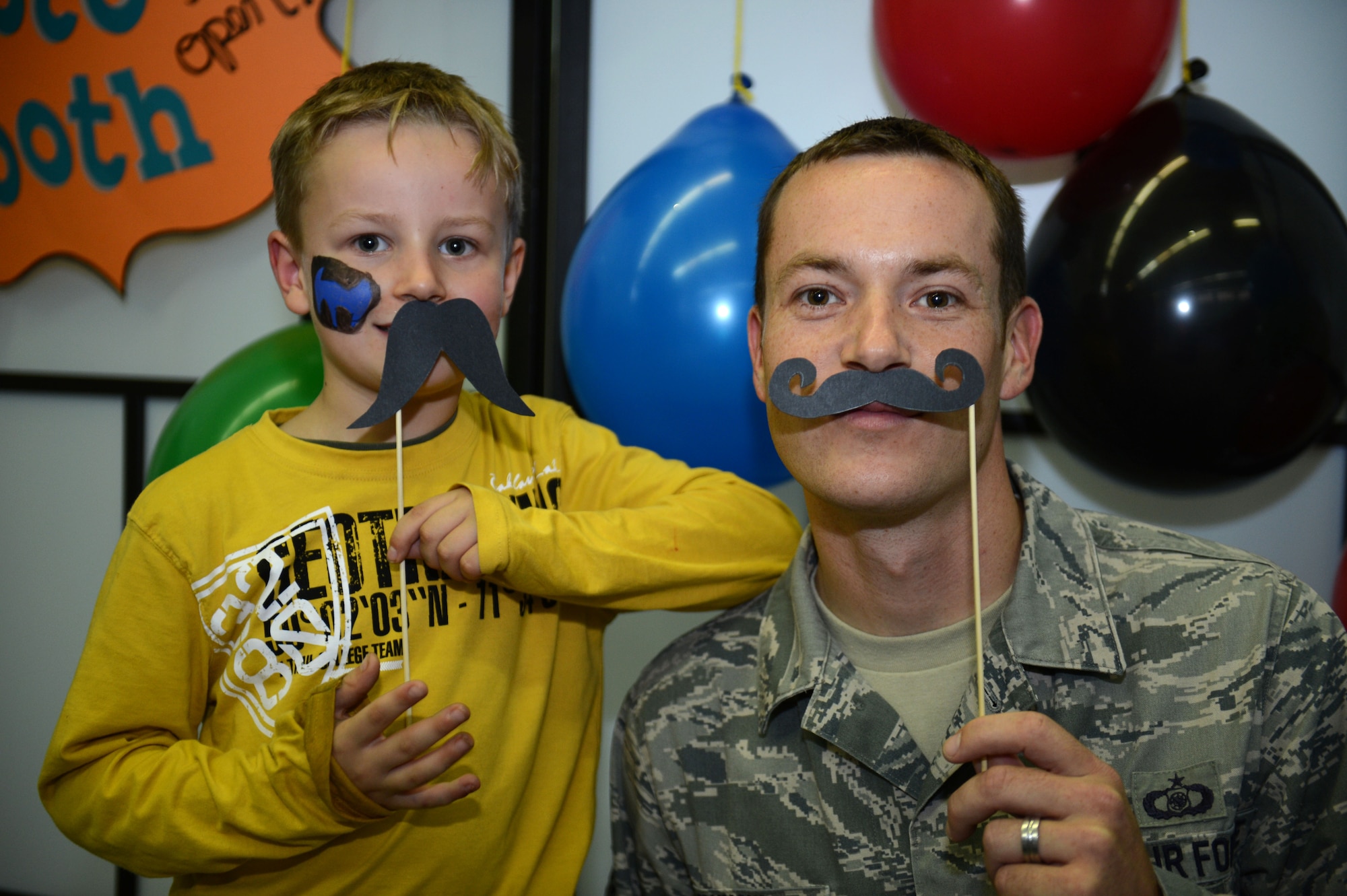SPANGDAHLEM AIR BASE, Germany – U.S. Air Force Staff Sgt. Jonathan Grunow, 606th Air Control Squadron weapons director from Detroit, poses for a photo with his son Landon at the School Age Program during a Lights On Afterschool event Oct. 18, 2012.  More than 7,500 Lights On Afterschool rallies are held annually. (U.S. Air Force photo by Airman 1st Class Gustavo Castillo/Released)