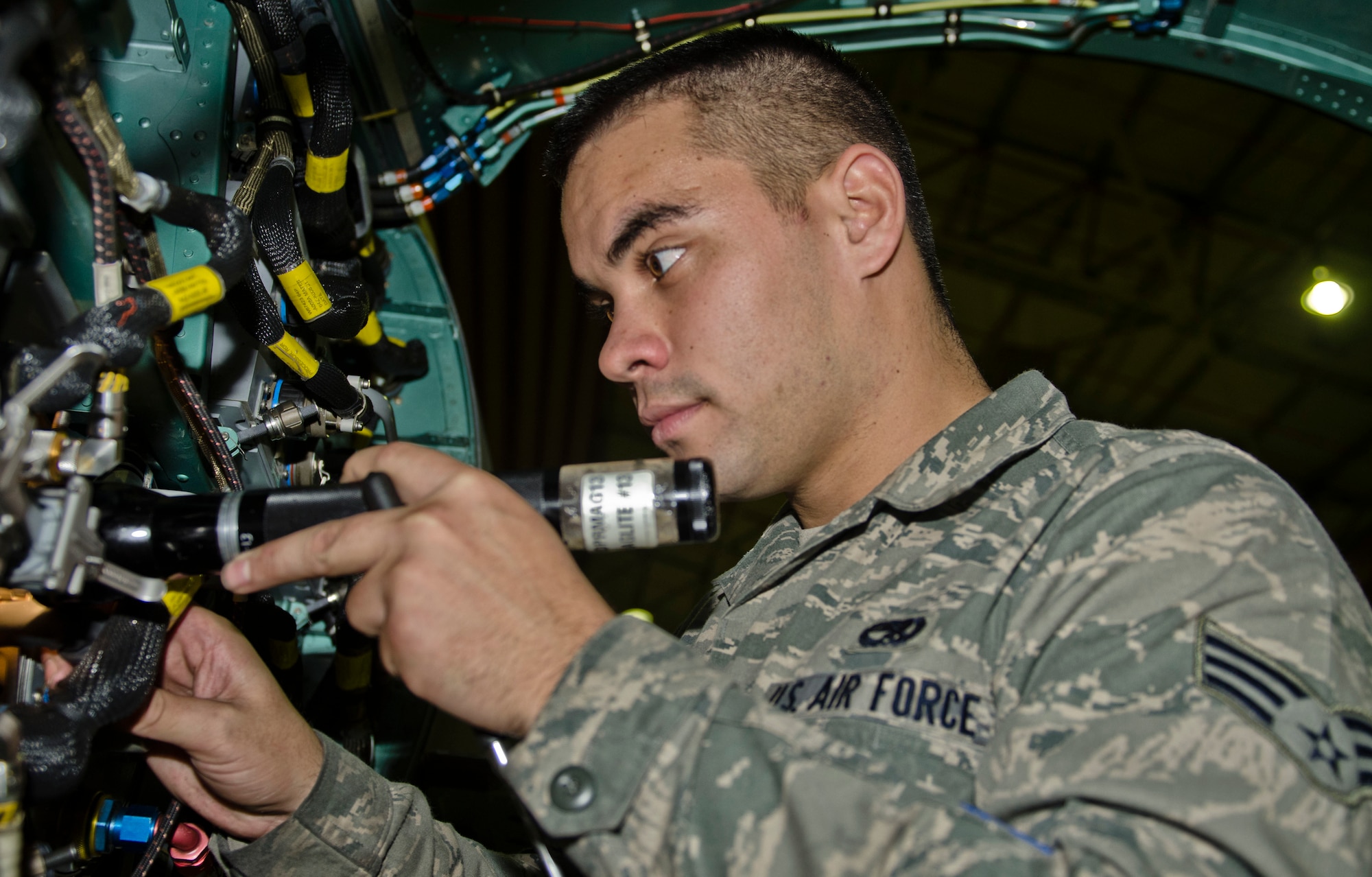 ROYAL AIR FORCE LAKENHEATH, England - Senior Airman Peter Soares, 48th Equipment Maintenance Suqadron inspection section journeyman and native of Honolulu, inspects connections on an F-15C Eagle, Oct. 17, 2012. The aircraft was turned over to the 48th EMS for 10 days of phase maintenance. During the maintenance, the 48th EMS Airmen essentially reverse 400 flight hours of wear and tear. (U.S. Air Force Photo by Staff Sgt. Stephen Linch)
