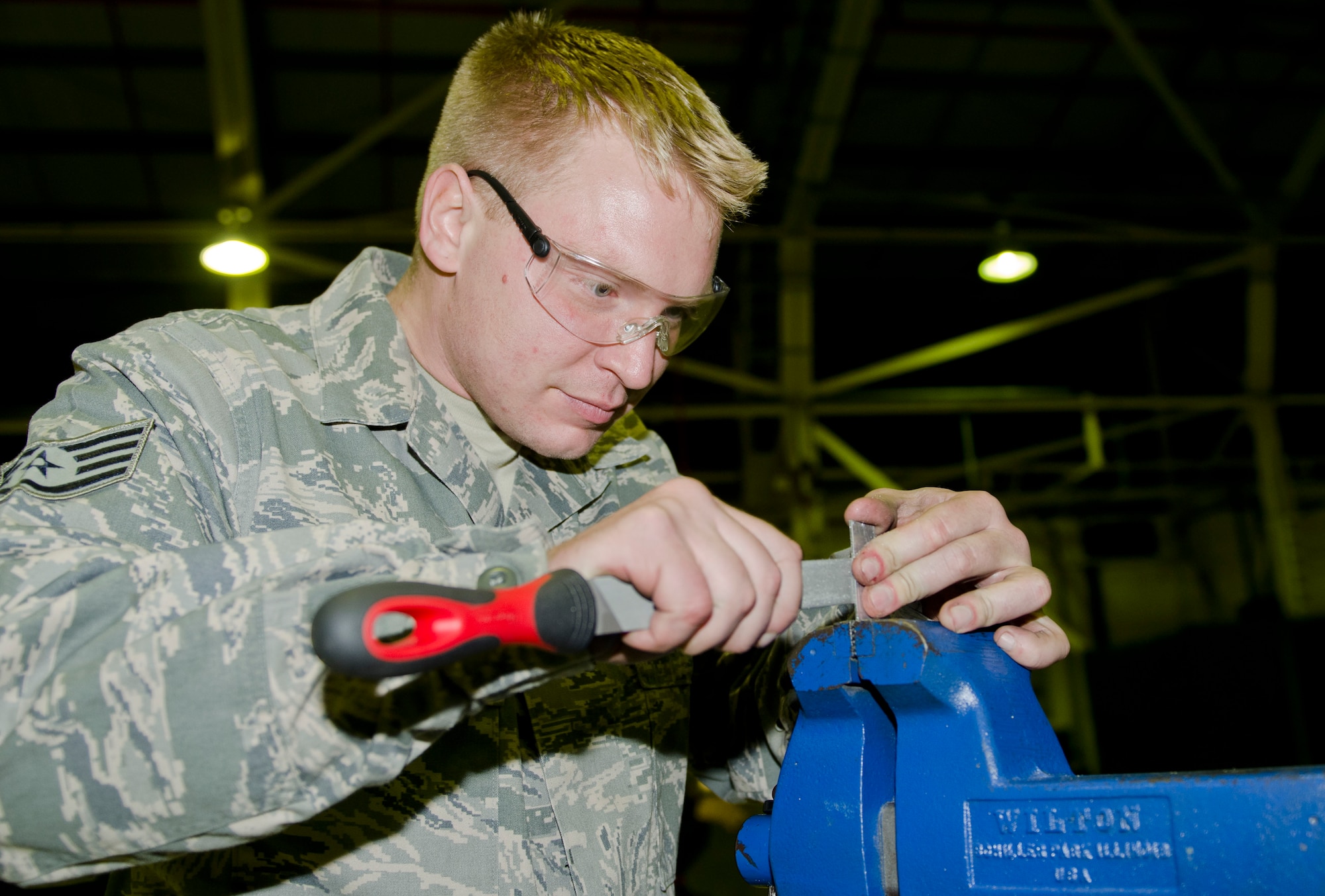 ROYAL AIR FORCE LAKENHEATH, England - Staff Sgt. Matthew Reynolds, 48th Equipment Maintenance Squadron inspection section craftsman and native of Kalamazoo, Mich., files a component of a boarding ladder for an F-15C Eagle, Oct. 16, 2012. Airmen from the 48th EMS inspect, restore and upgrade aircraft during a 10-day maintenance process known as phase maintenance. (U.S. Air Force Photo by Staff Sgt. Stephen Linch)