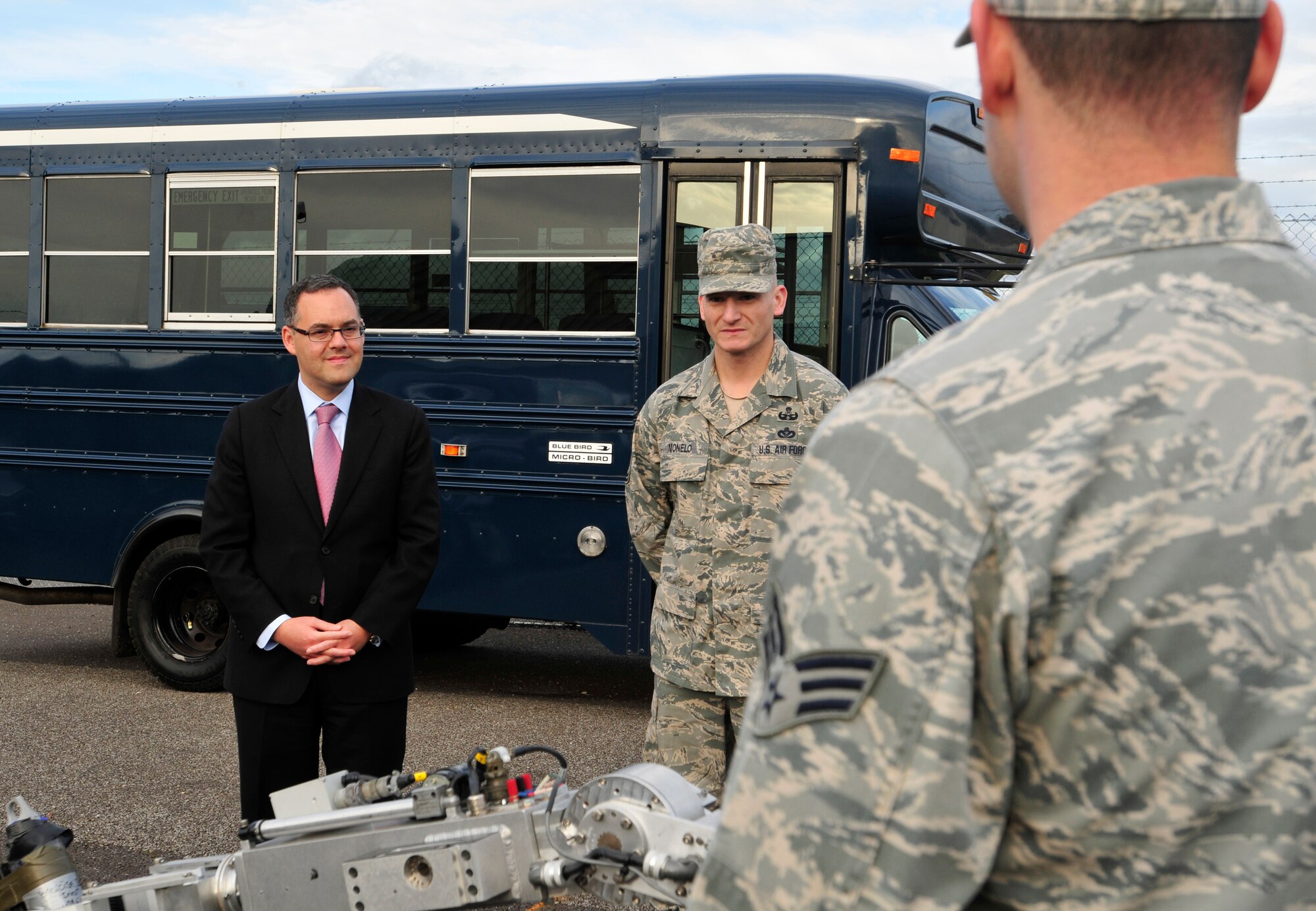 ROYAL AIR FORCE LAKENHEATH, England – The Honorable Daniel Ginsberg, Assistant Secretary of the Air Force for Manpower and Reserve Affairs (left), stands with Master Sgt. Jacob Monelo, 48th Civil Engineer Squadron explosive ordnance disposal team member, as Senior Airman Jeffrey Butera, 48th CES EOD team member, explains the functions of their robot at the EOD building Oct. 19. 2012. Members of the EOD team showed Ginsberg their robot and bomb disposal suit during his visit to various squadrons around RAF Lakenheath. (U.S. Air Force photo by Senior Airman Tiffany M. Grigg)