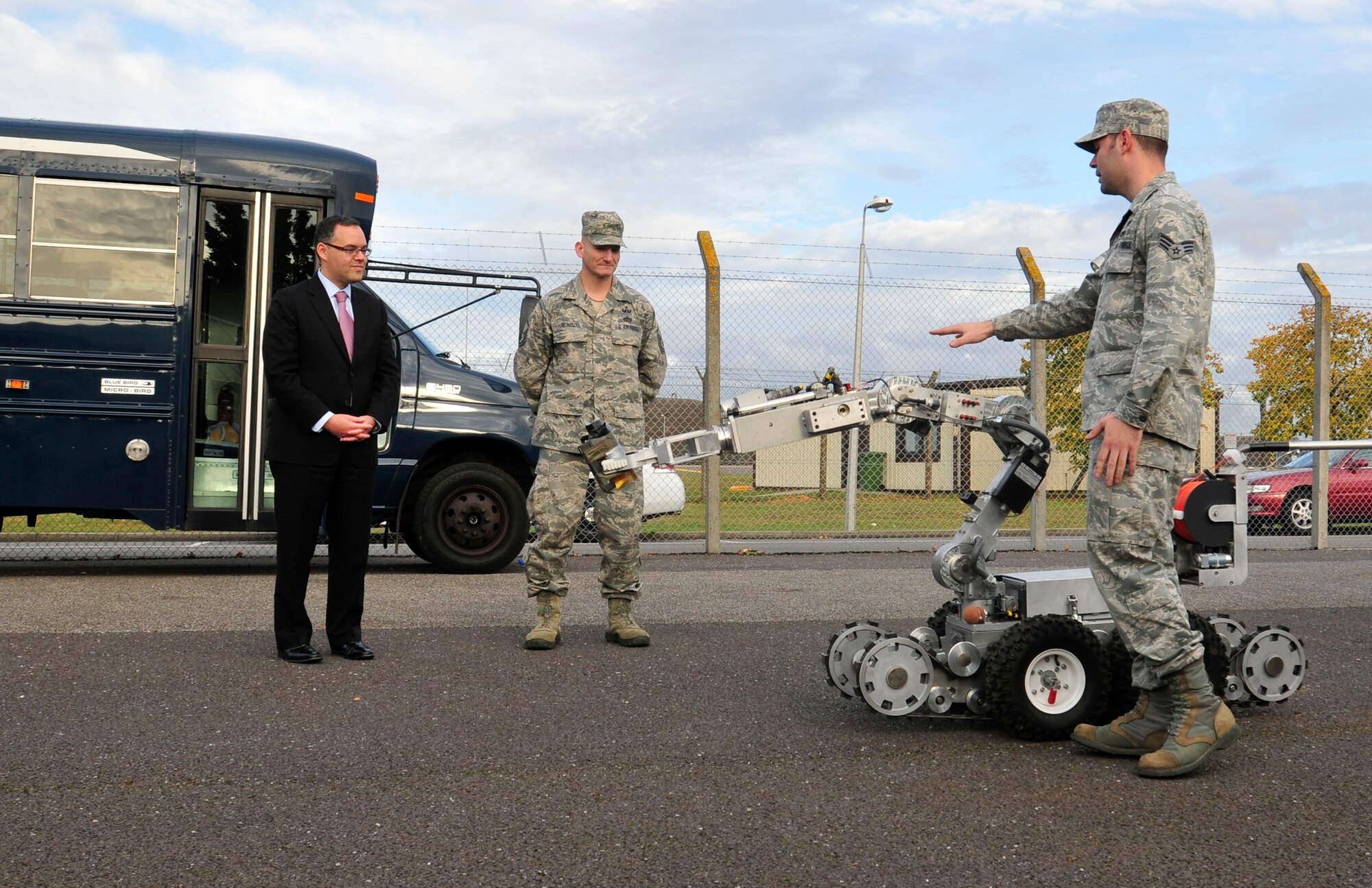 ROYAL AIR FORCE LAKENHEATH, England – The Honorable Daniel Ginsberg, Assistant Secretary of the Air Force for Manpower and Reserve Affairs (left), stands with Master Sgt. Jacob Monelo, 48th Civil Engineer Squadron explosive ordnance disposal team member, as Senior Airman Jeffrey Butera, 48th CES EOD team member, explains the functions of their robot at the EOD building Oct. 19. 2012. Members of the EOD team showed Ginsberg their robot and bomb disposal suit during his visit to various squadrons around RAF Lakenheath. (U.S. Air Force photo by Senior Airman Tiffany M. Grigg)