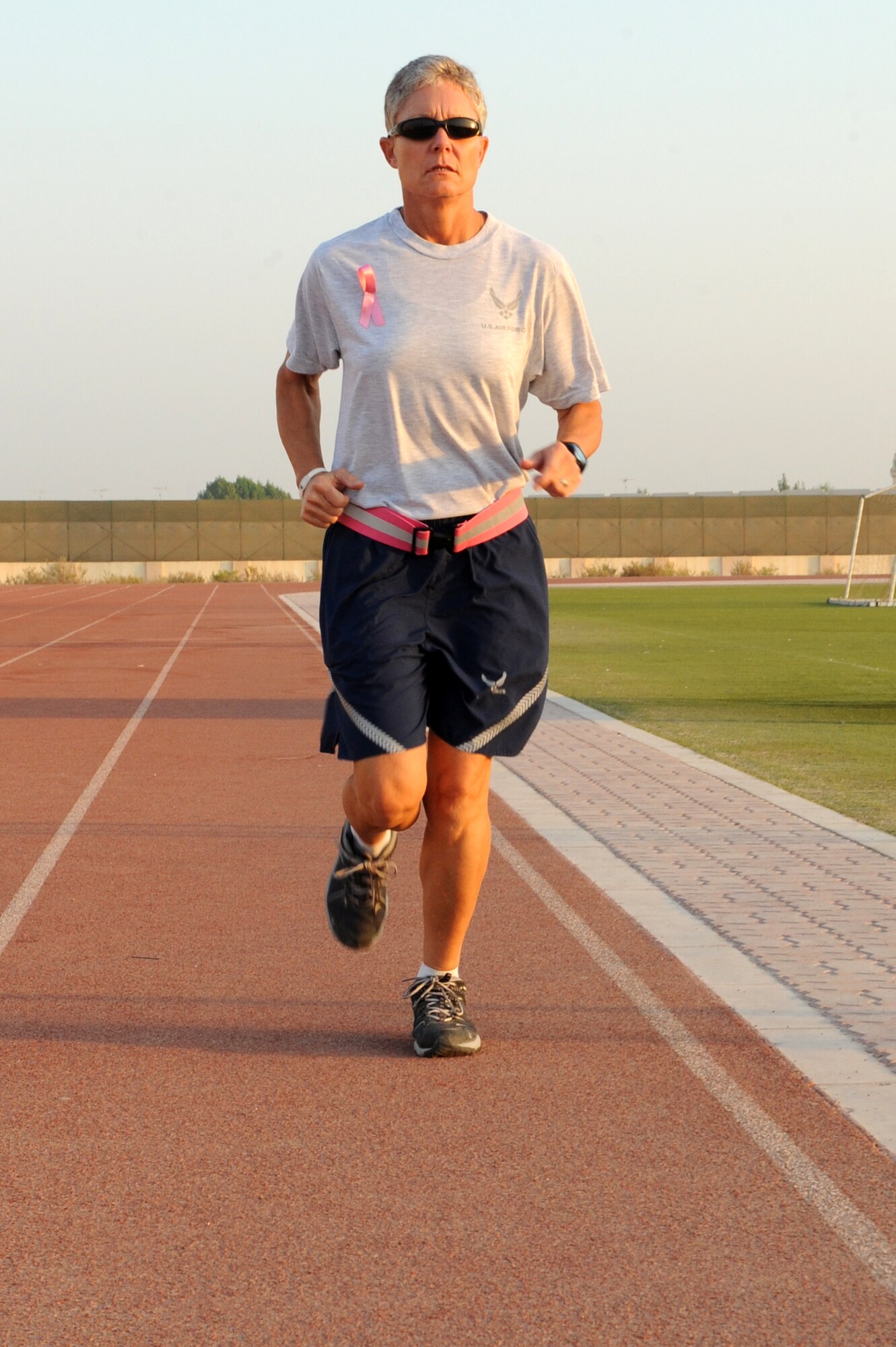 SOUTHWEST ASIA - U.S. Air Force Master Sgt. Laurie Cherry, 727th Expeditionary Air Control Squadron first sergeant, runs on a track at the 380th Air Expeditionary Wing Oct. 17, 2012. Cherry is training for the Susan G. Komen three-day walk for breast cancer research and awareness Nov. 9-11.  (U.S. Air Force photo/Master Sgt. Scott MacKay)