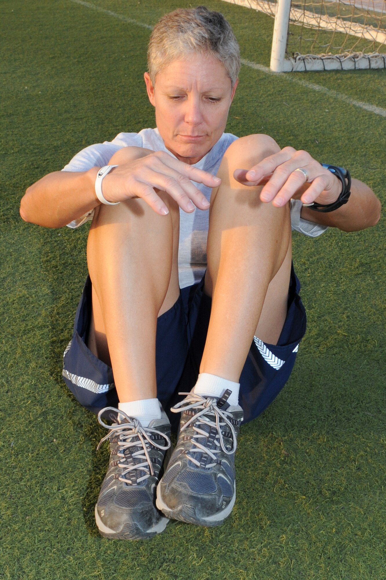 SOUTHWEST ASIA - U.S. Air Force Master Sgt. Laurie Cherry, 727th Expeditionary Air Control Squadron first sergeant, does crunches as part of her training for the Susan G. Komen three-day walk for breast cancer research and awareness Oct. 17, 2012. Cherry signed up to participate in the event Nov. 9-11 in Phoenix, but due to deployment will participate in the walk from the 380th Air Expeditionary Wing.  (U.S. Air Force photo/Master Sgt. Scott MacKay)